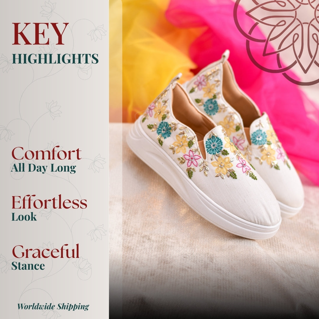 White slip on with colorful floral embroidery, lightweight sole, and soft lining for everyday look.