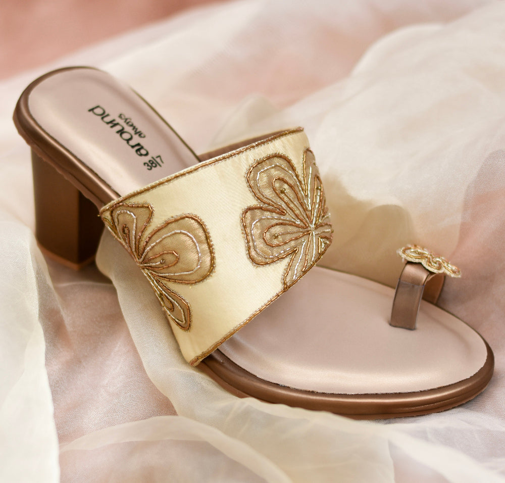 Gold block heel sandal with embroidered strap and matching toe motif
