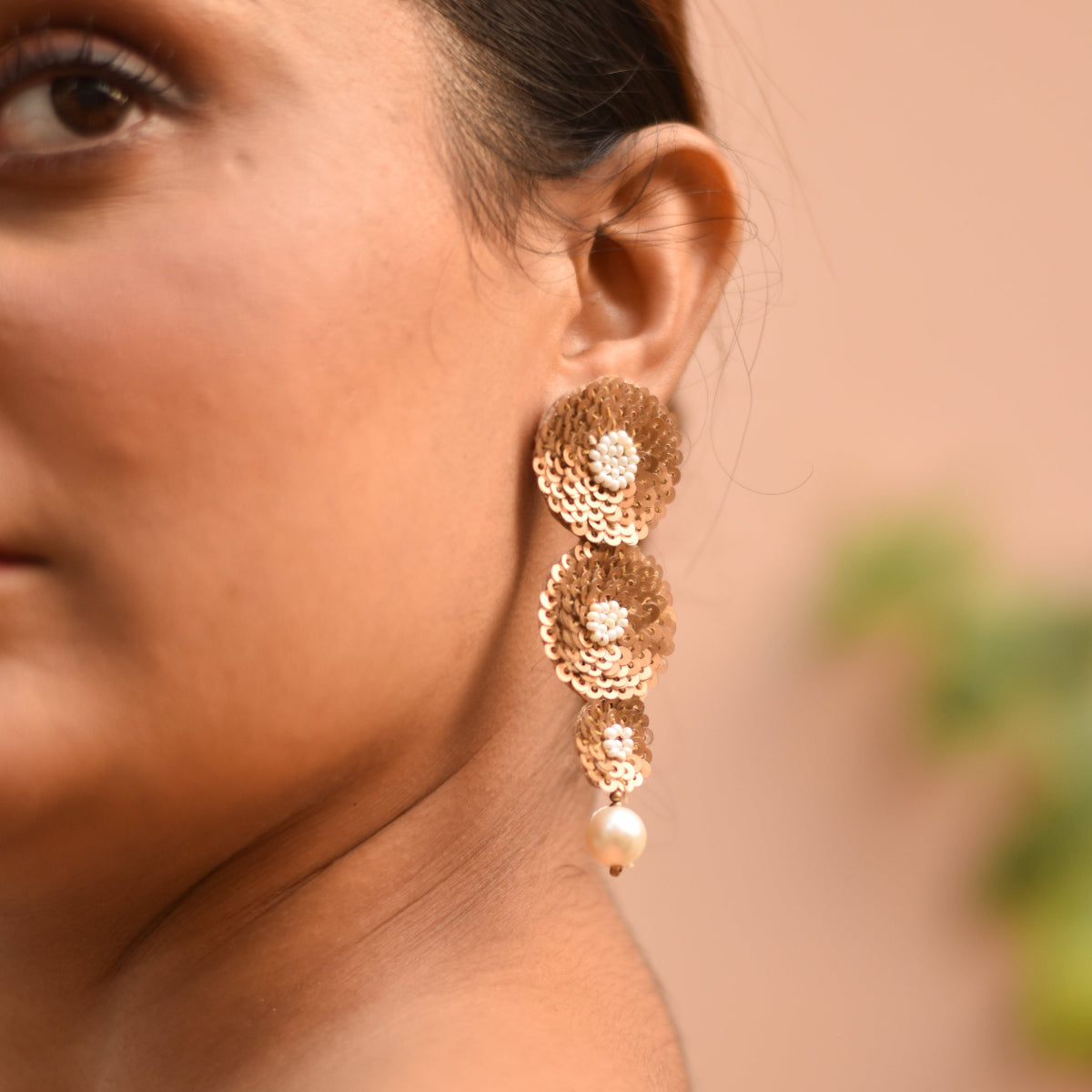 Handmade gold-toned earrings with bead centre design
