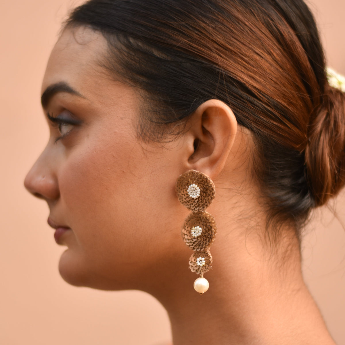Handmade gold-toned earrings with bead centre design