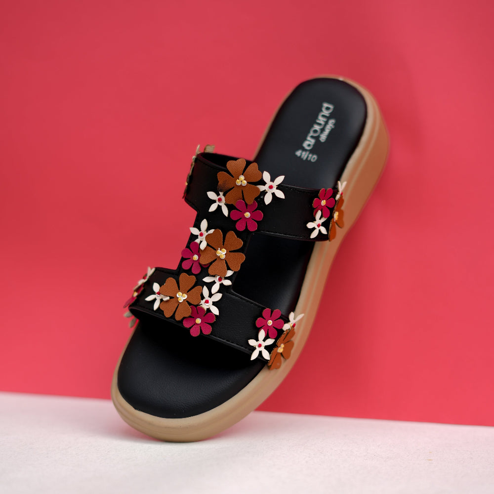 Black floral sandal with two decorated straps and raised sole
