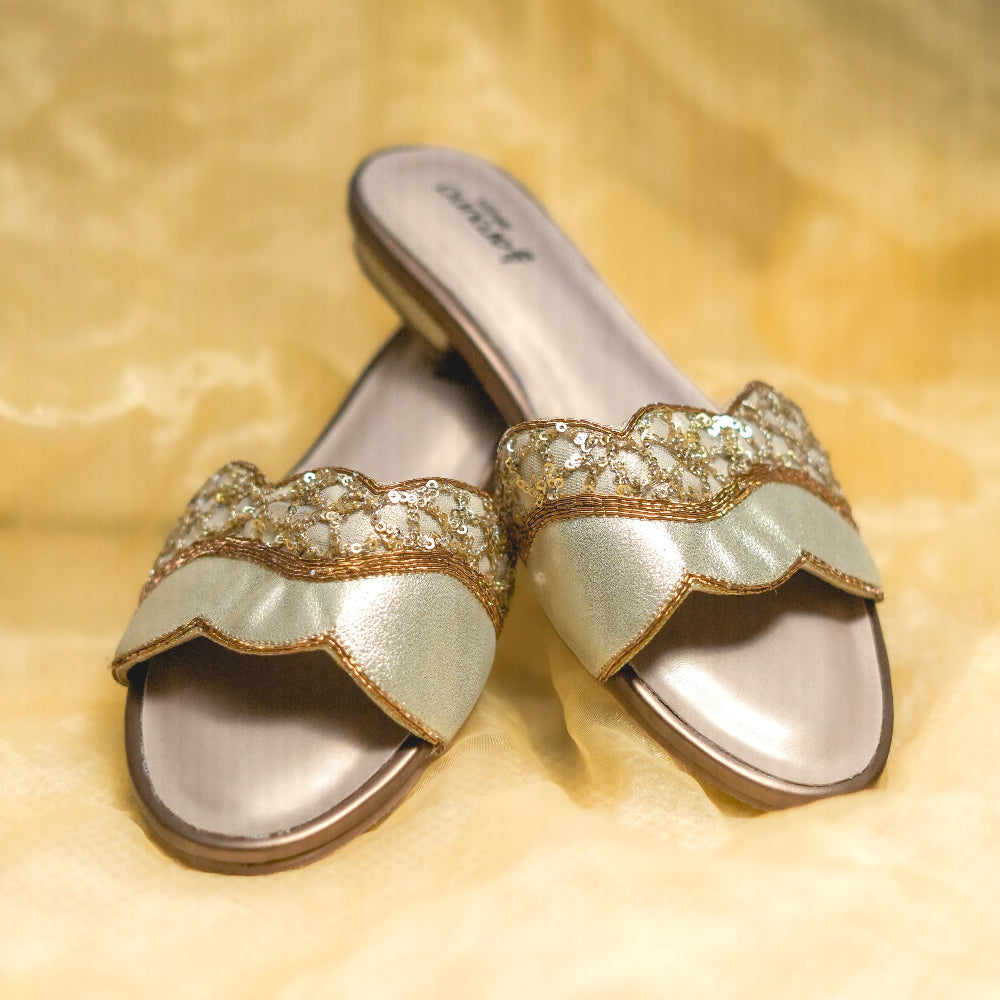 Gold scalloped flats with sequin detailing for festive wear
