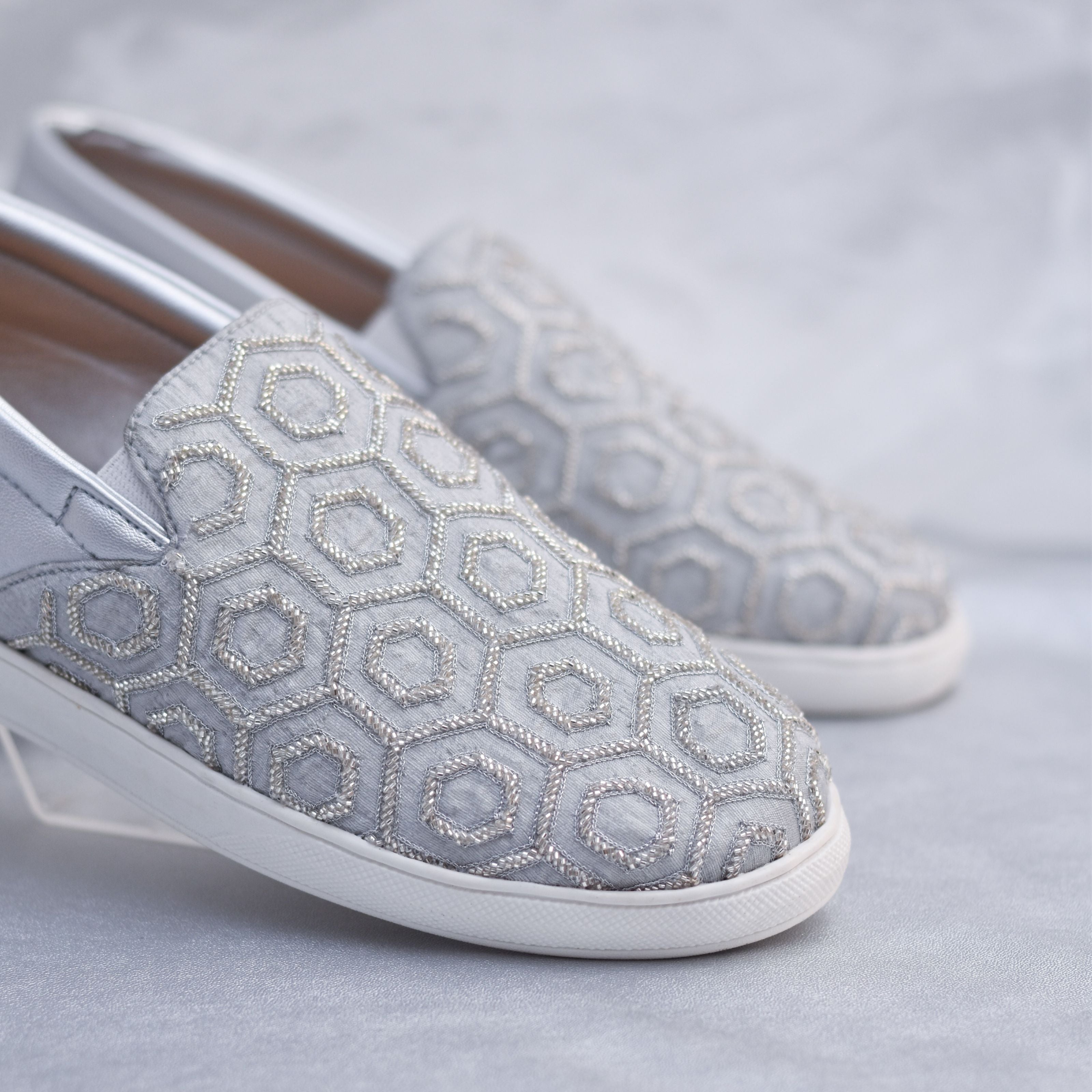 Handcrafted Indian wedding shoes for men with metallic beads detailing.