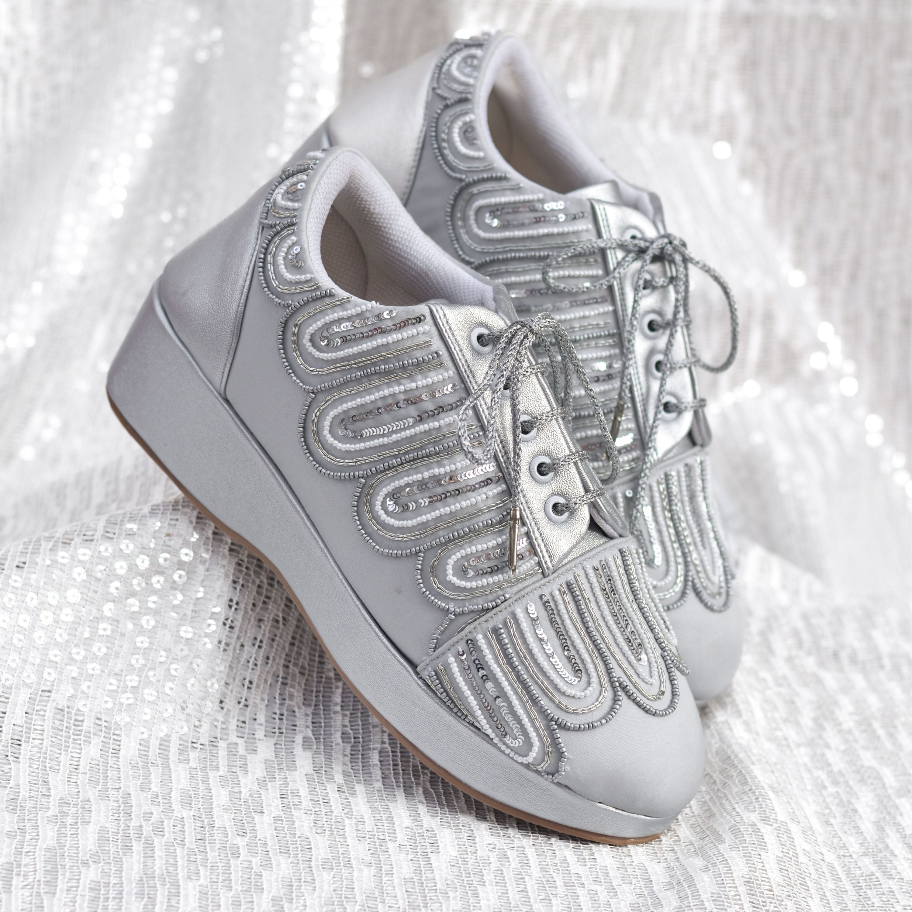 Comfortable silver wedge shoes with sequin detailing.