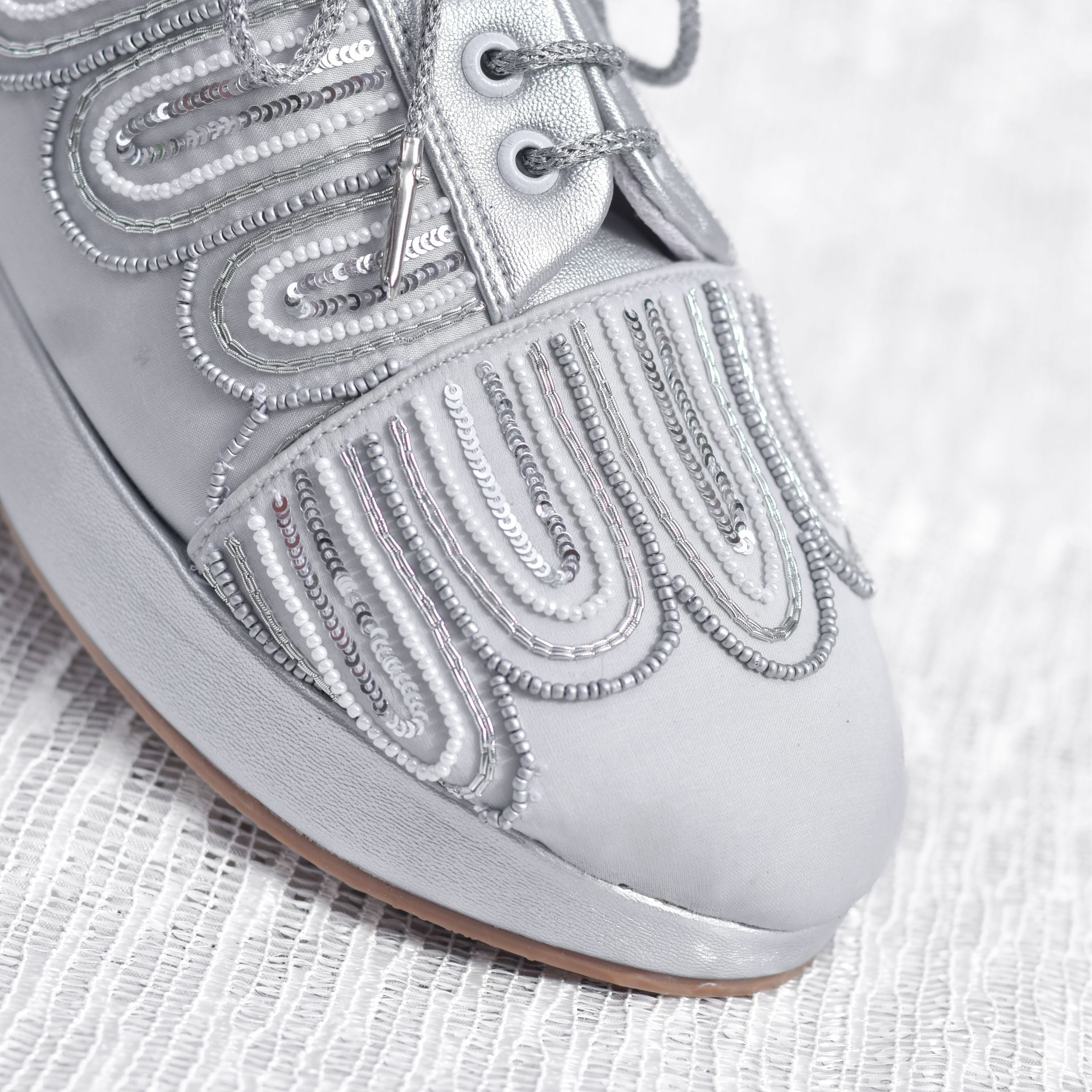 Designer metallic wedge sneakers for cocktail and reception.