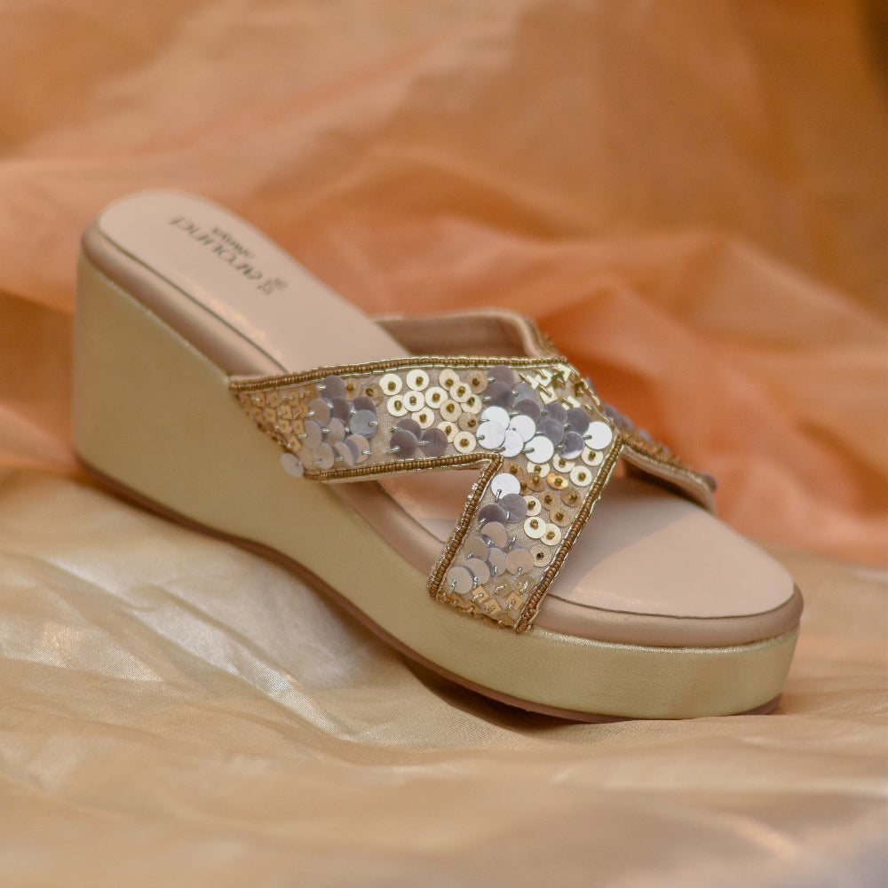Ivory platform wedges with hand-finished sequin embellished crossover straps.
