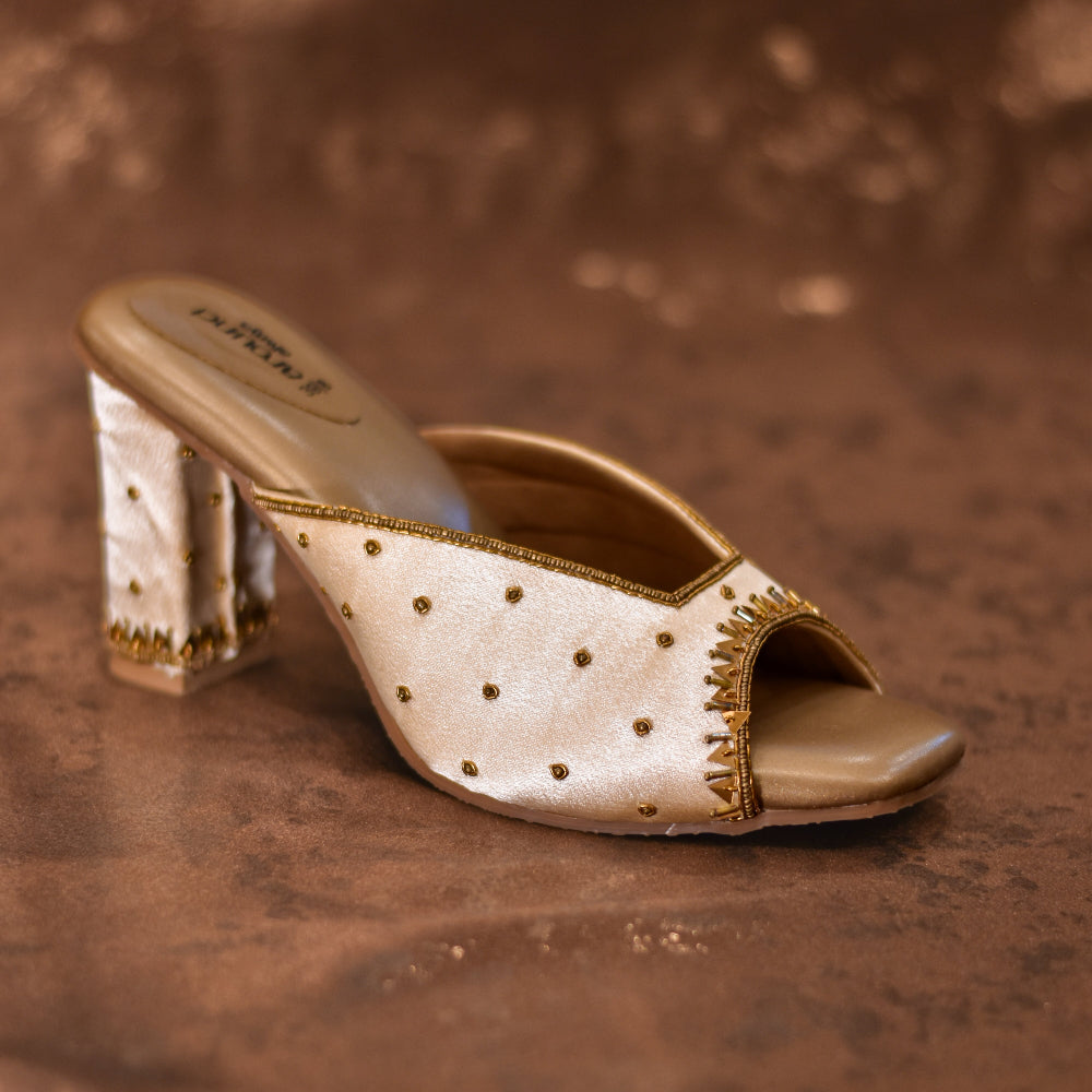 Ivory open toe mule heels with metallic embroidery and high heel