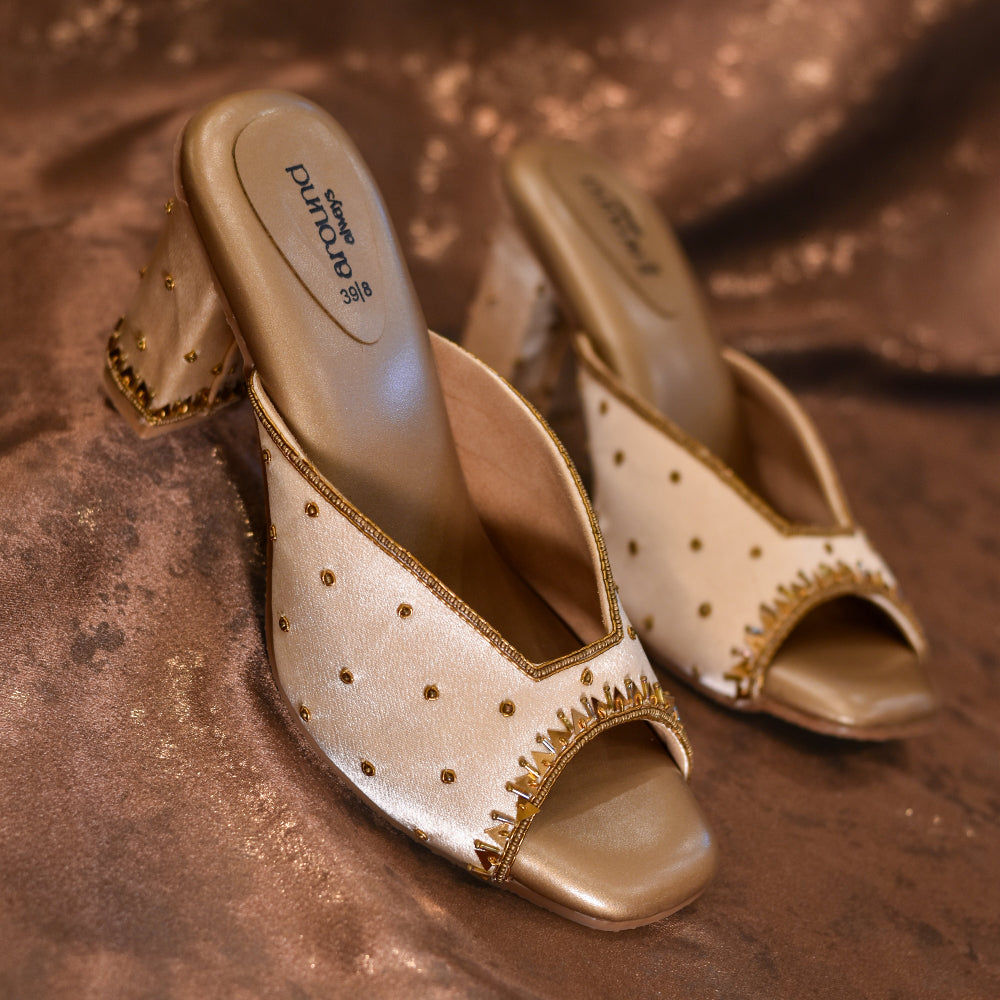Pair of gold high-heeled shoes with antislip sole