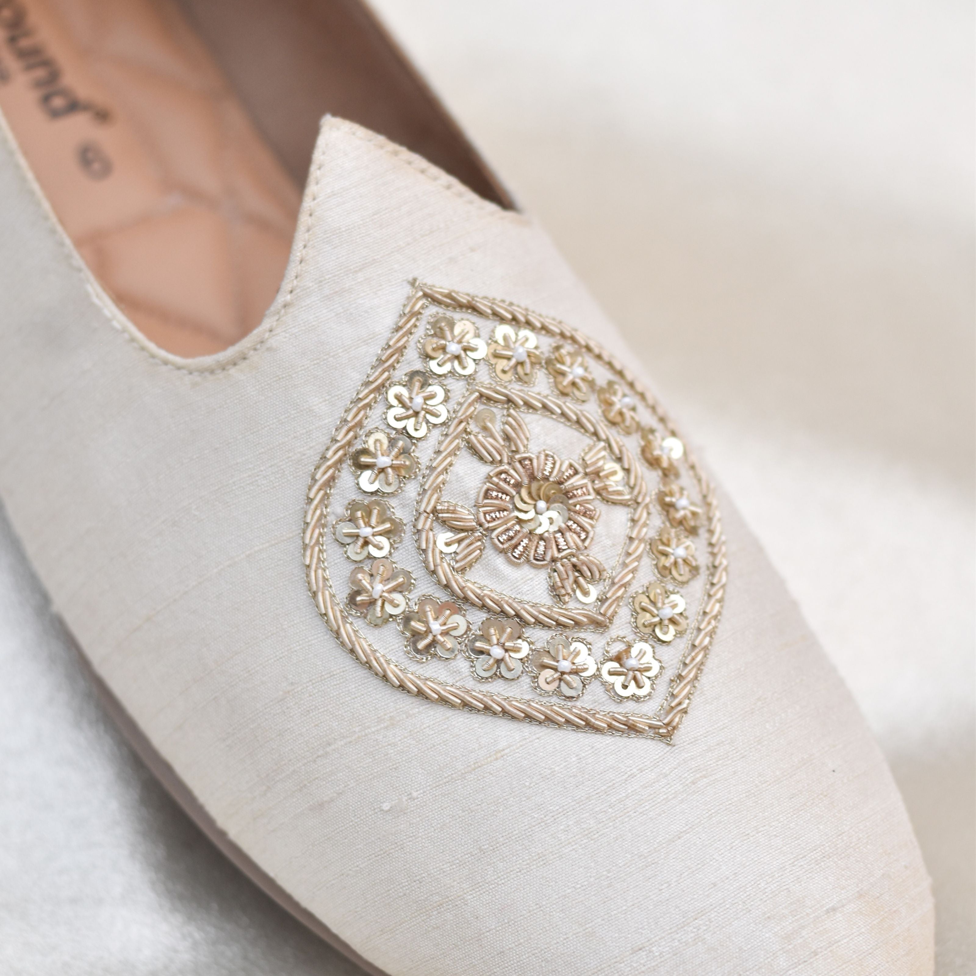 Handcrafted festive slip-ons for men with golden metallic detailing.