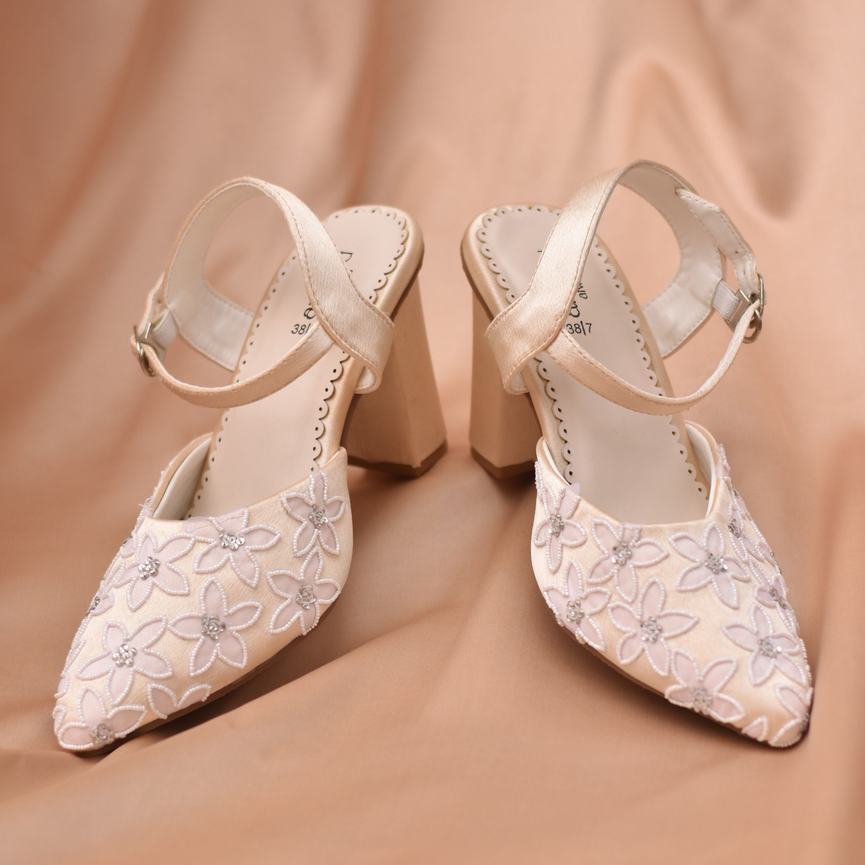 Beige high-heeled shoes with floral embroidery and cushioned insole