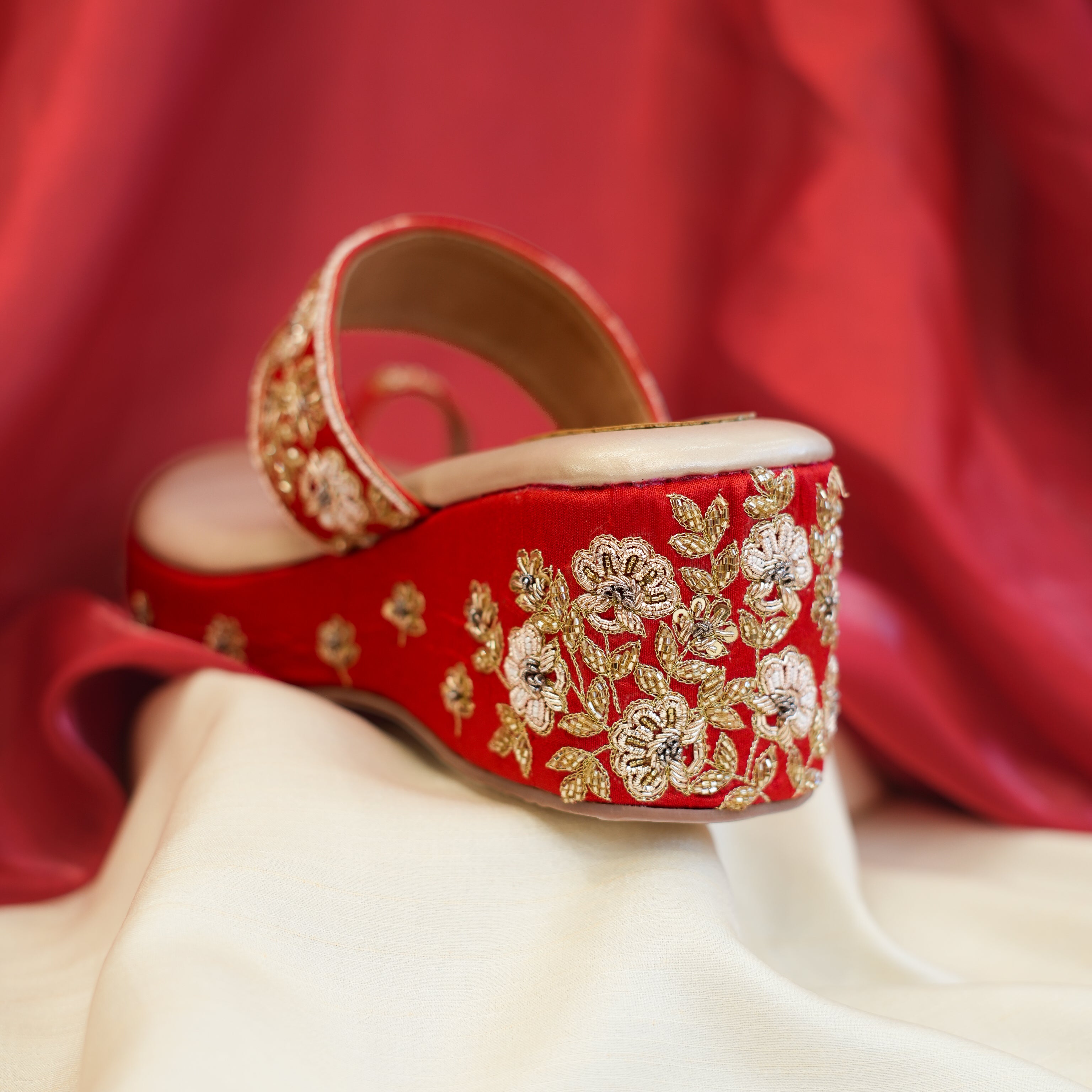 Festive red platform sandals with floral embroidery
