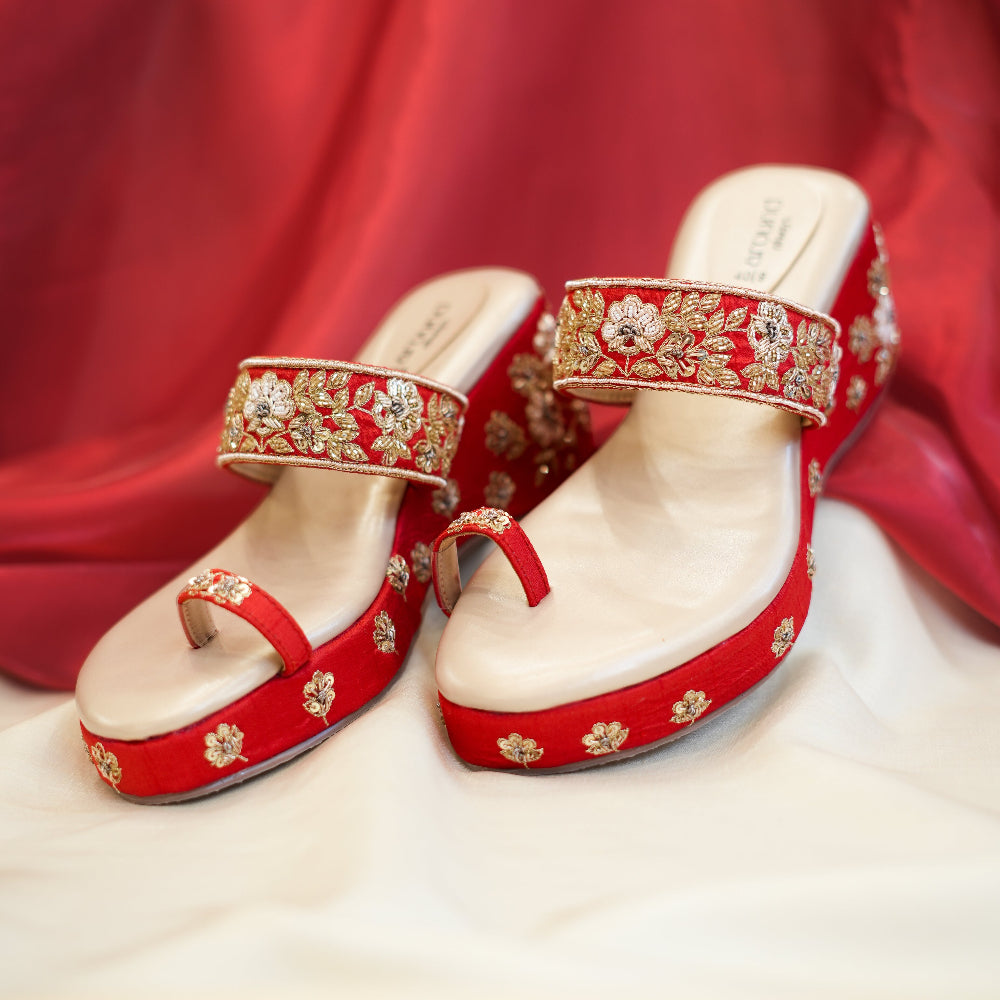 Red platform wedge sandals with embellished floral upper
