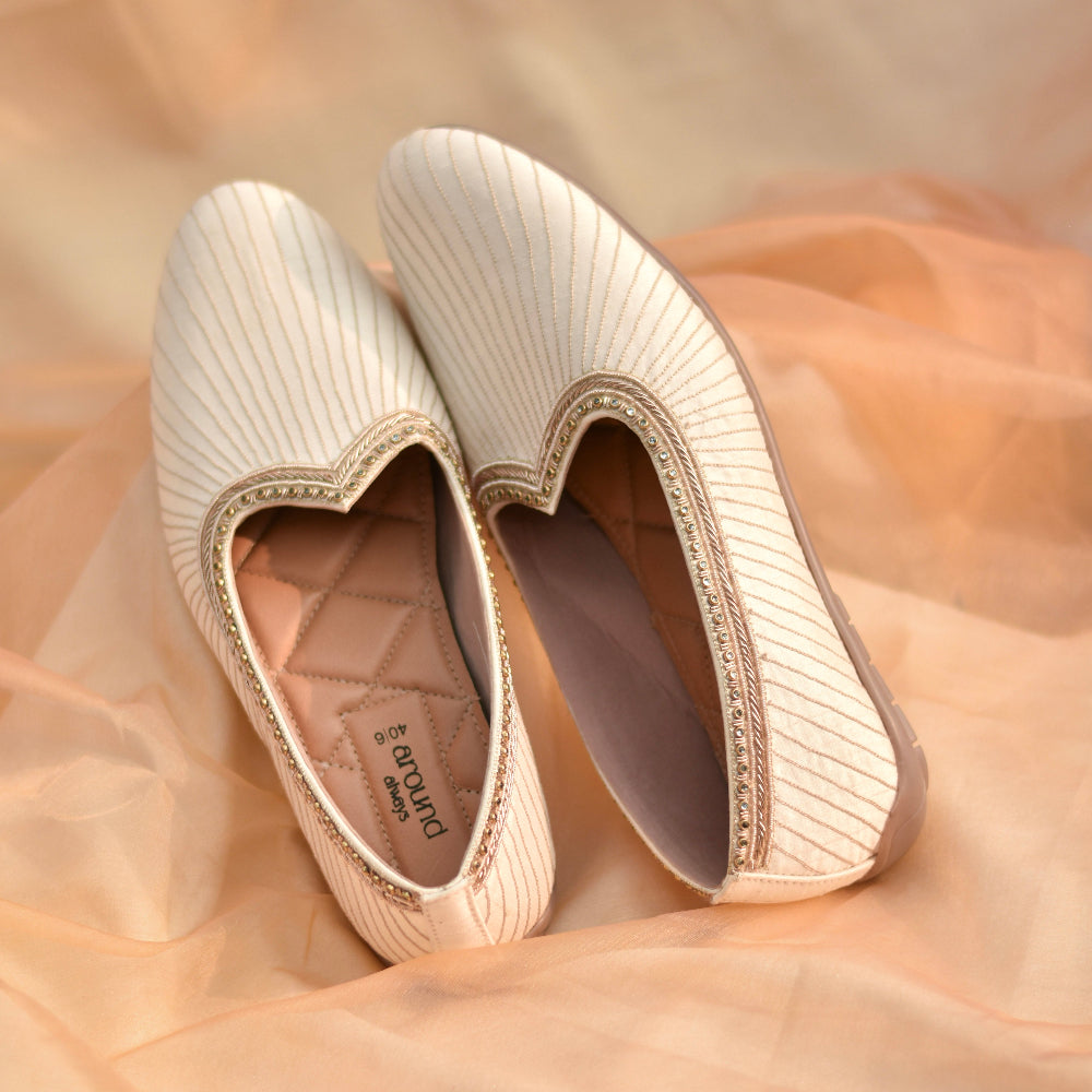 Ethnic ivory footwear with structured stitch lines and edge work
