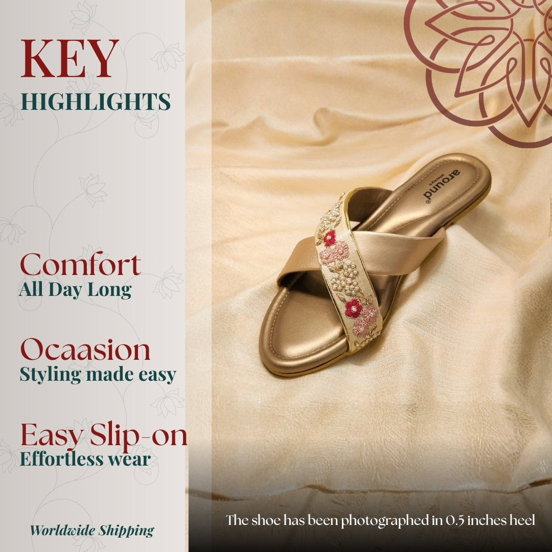 Gold slip on sandals with floral embroidery and cross straps, soft cushioned footbed and easy wear festive styling