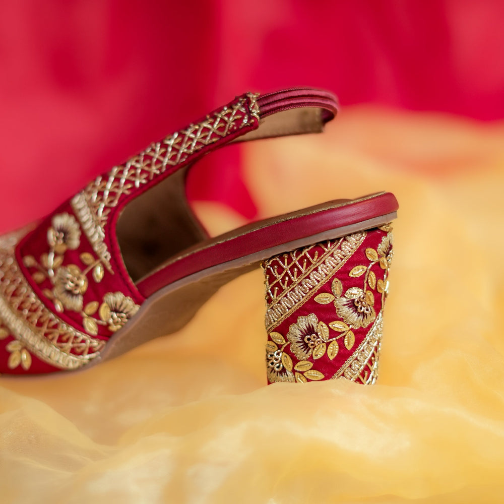 Crimson slingback block heels with golden floral embroidery and lattice detailing
