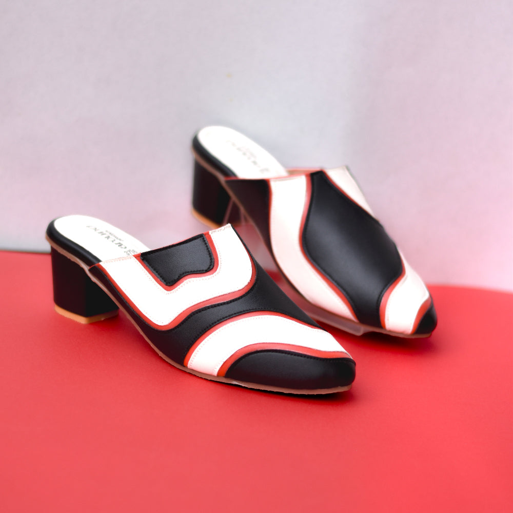 Black heeled mule with curved contrasting panels and pointed front
