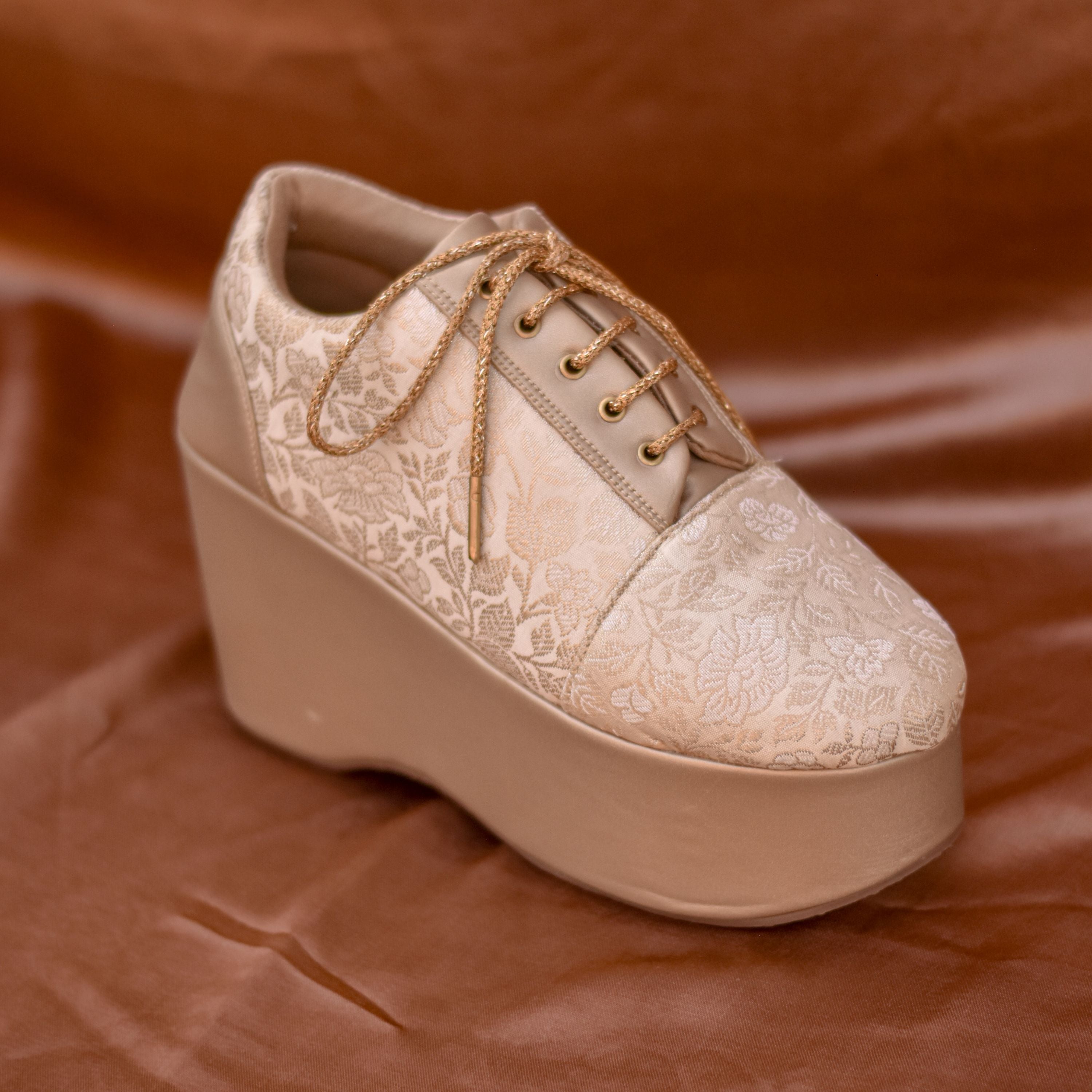 Festive brocade sneaker wedge with golden laces.