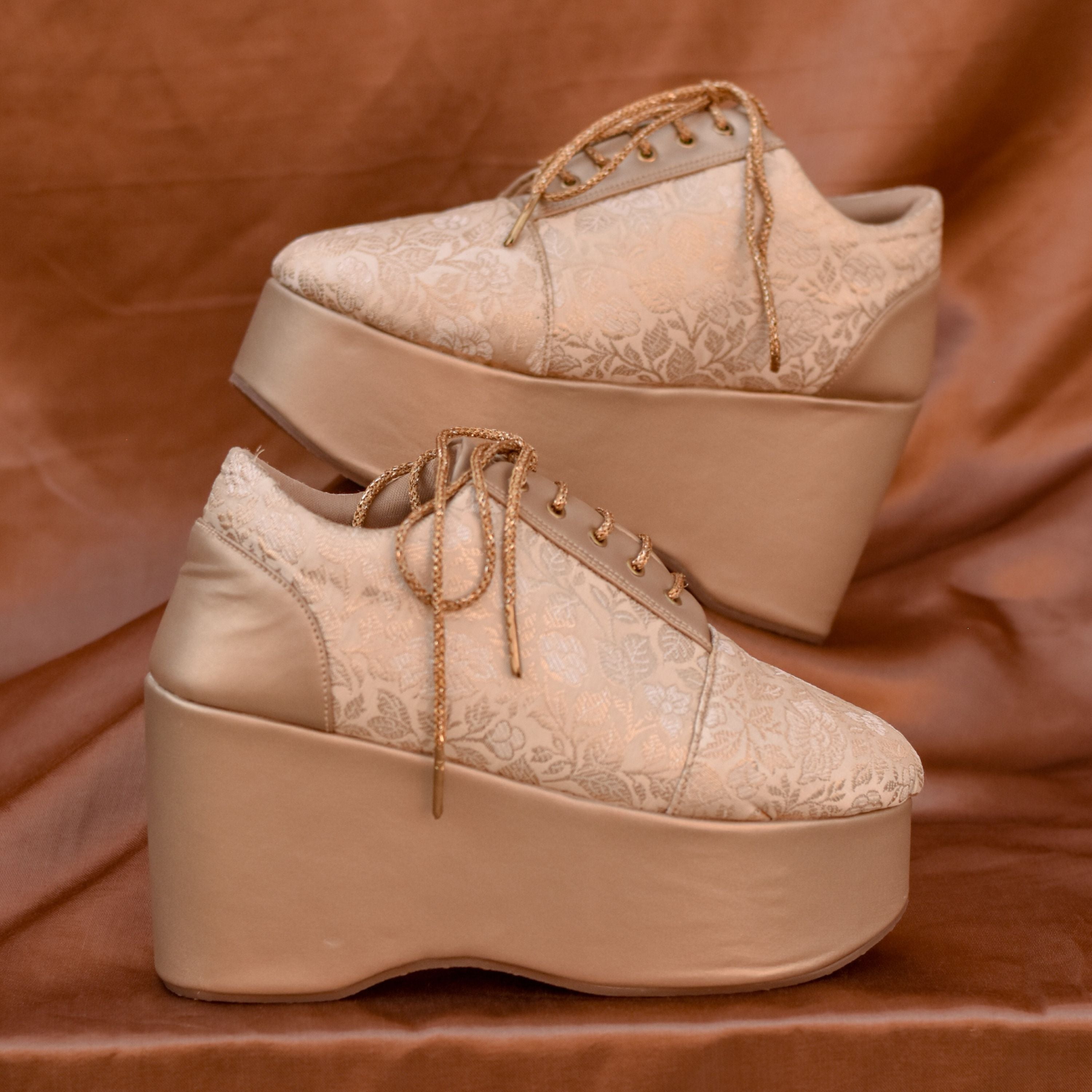 Champagne gold sneaker wedge with floral brocade pattern.