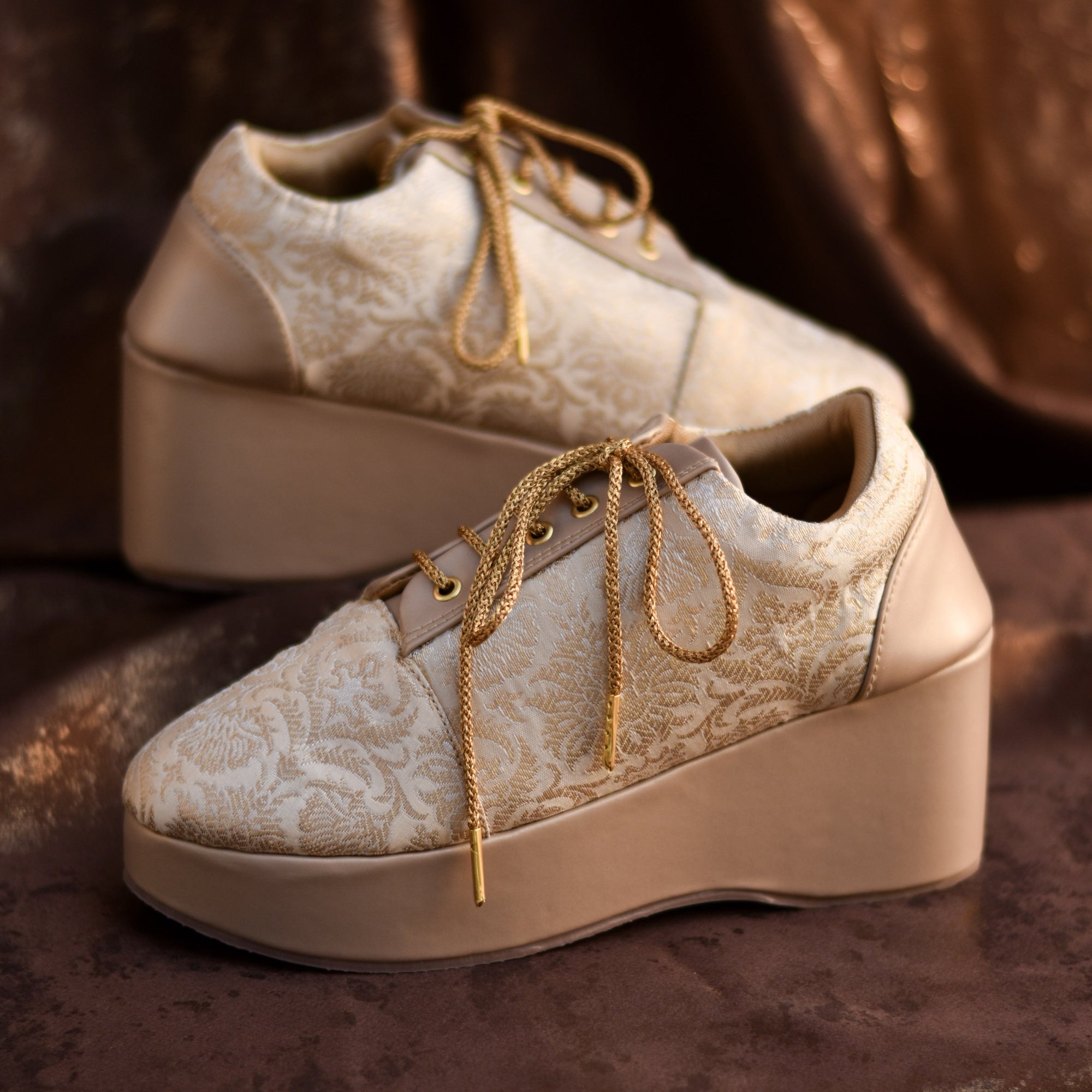Champagne gold sneaker wedge with floral brocade pattern and laceup design