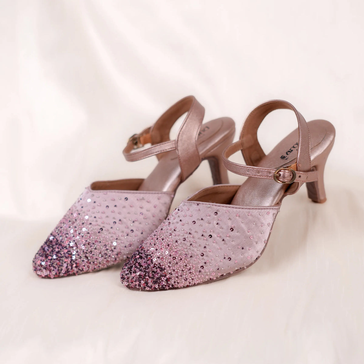 Shimmery pastel mules with ankle strap for support while dancing at parties