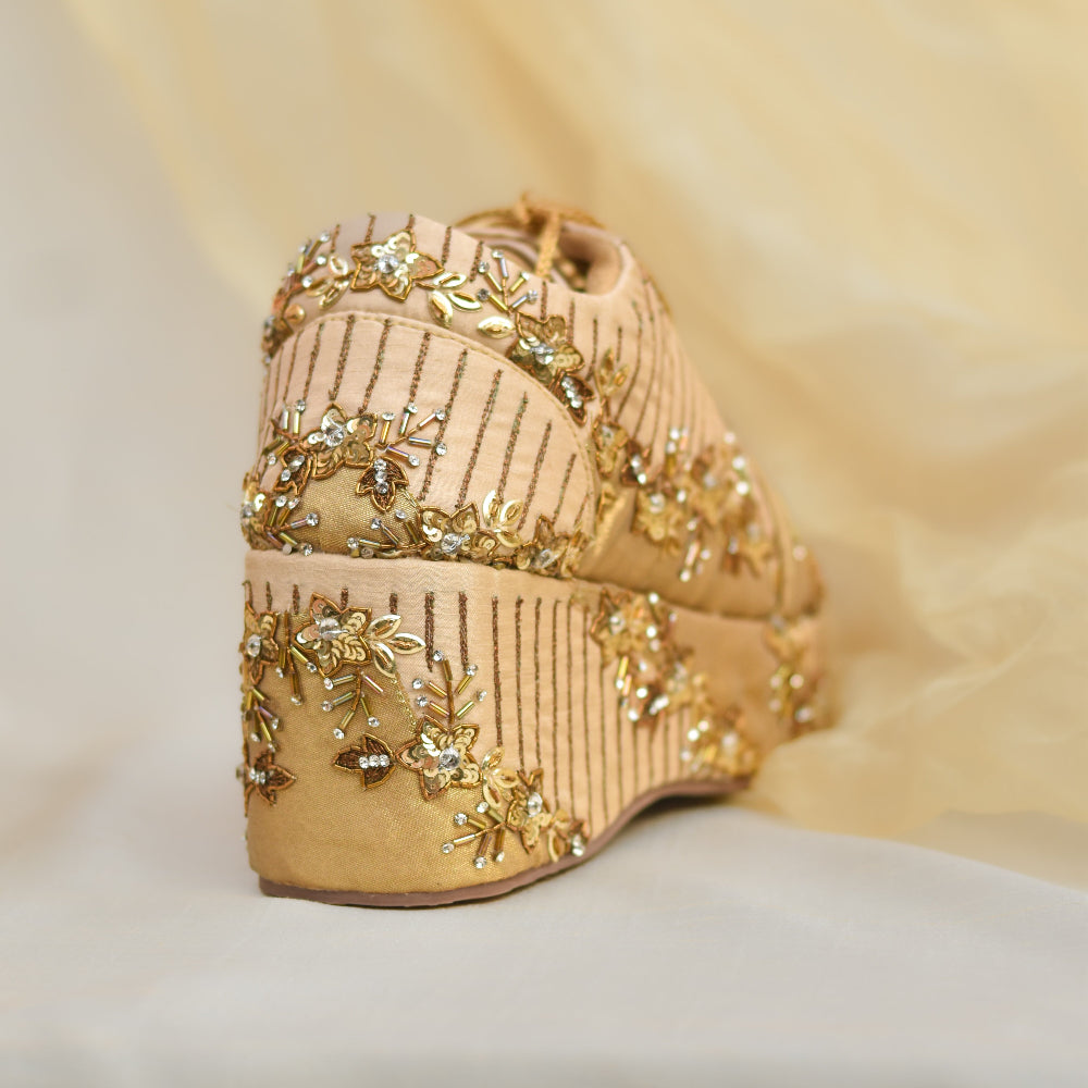 Festive sneakers featuring metallic floral motifs and textured panels