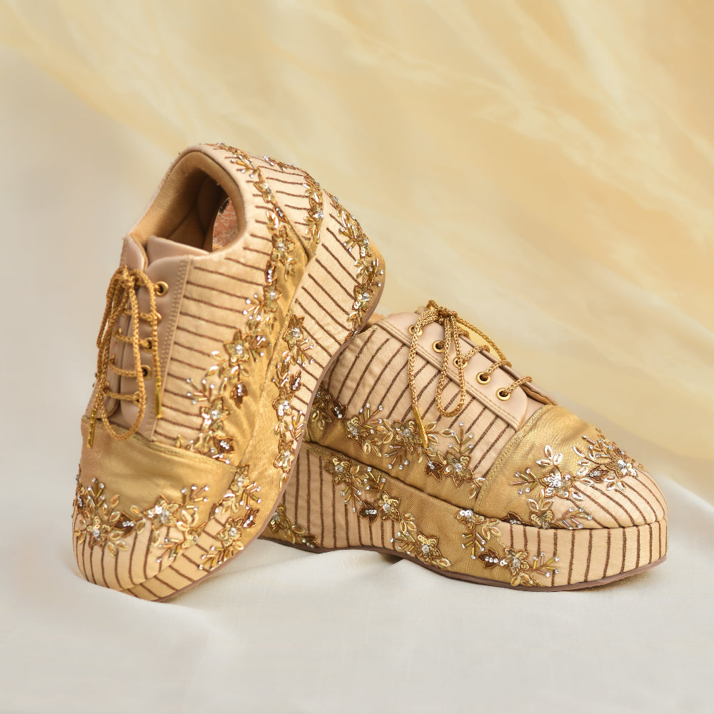 Designer wedge sneakers with gold threadwork and shimmer accents