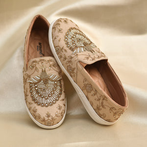 Handcrafted ethnic sneakers with regal peacock design and textured stitching.