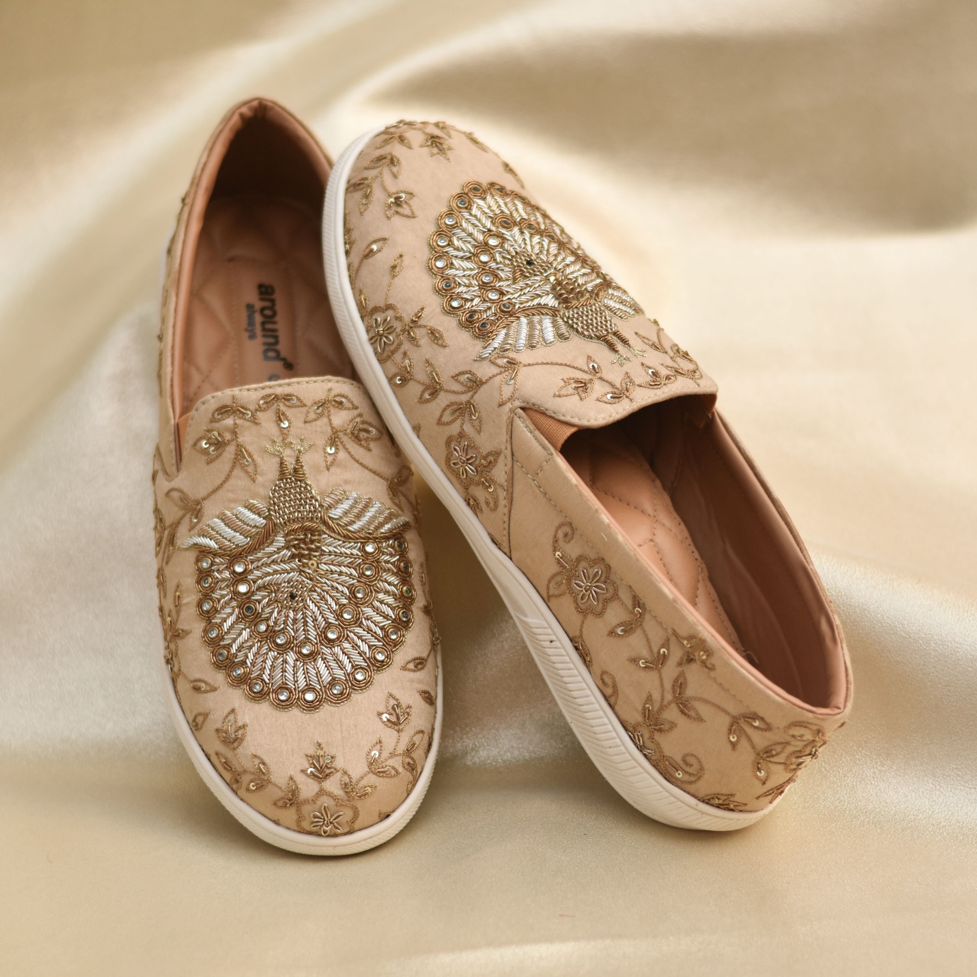 Handcrafted ethnic sneakers with regal peacock design and textured stitching.