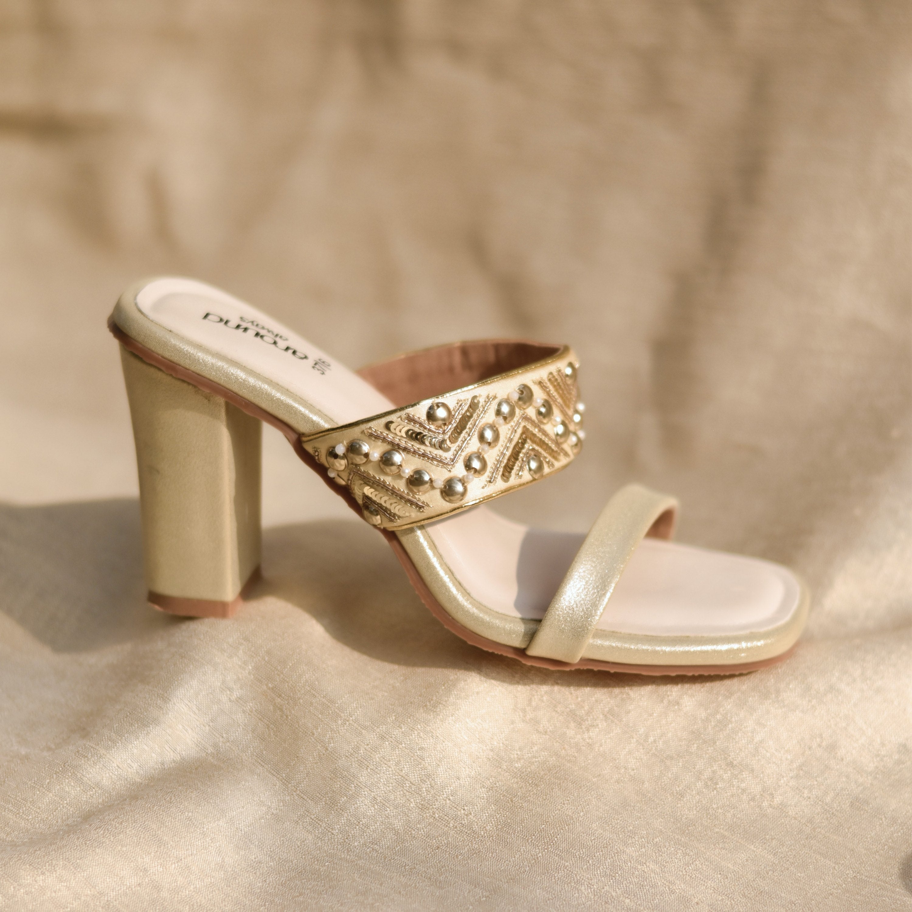 Golden ethnic footwear for women in high-heel and wide fit options