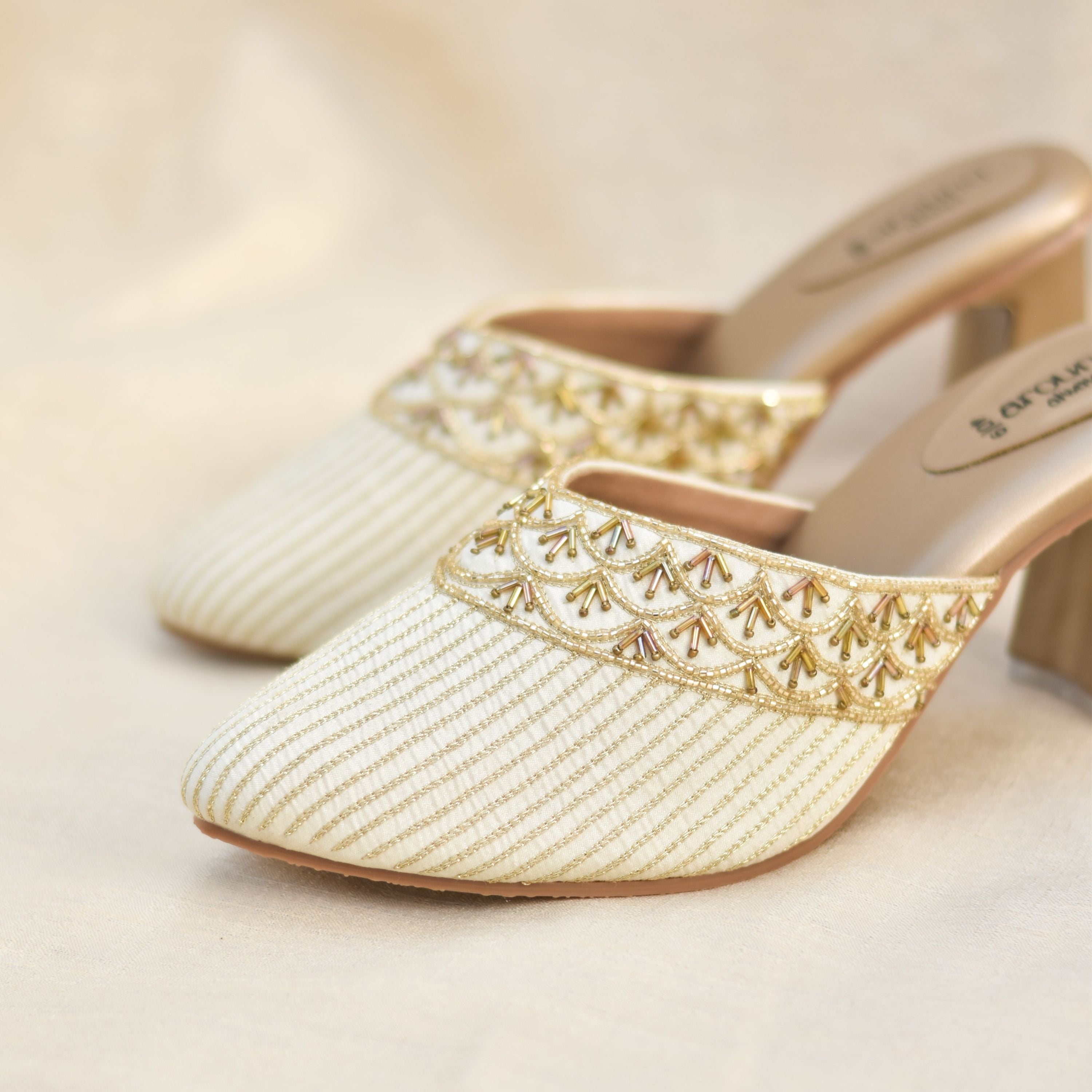 Elegant block heel mules in ivory and gold for festive wear.