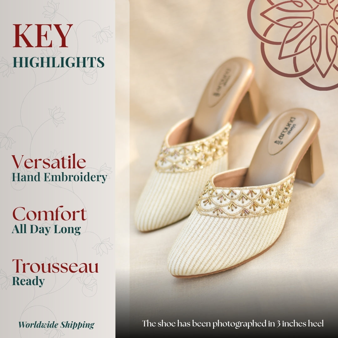 Ivory block heel mules with pointed toe, intricate handwork detailing, cushioned insole