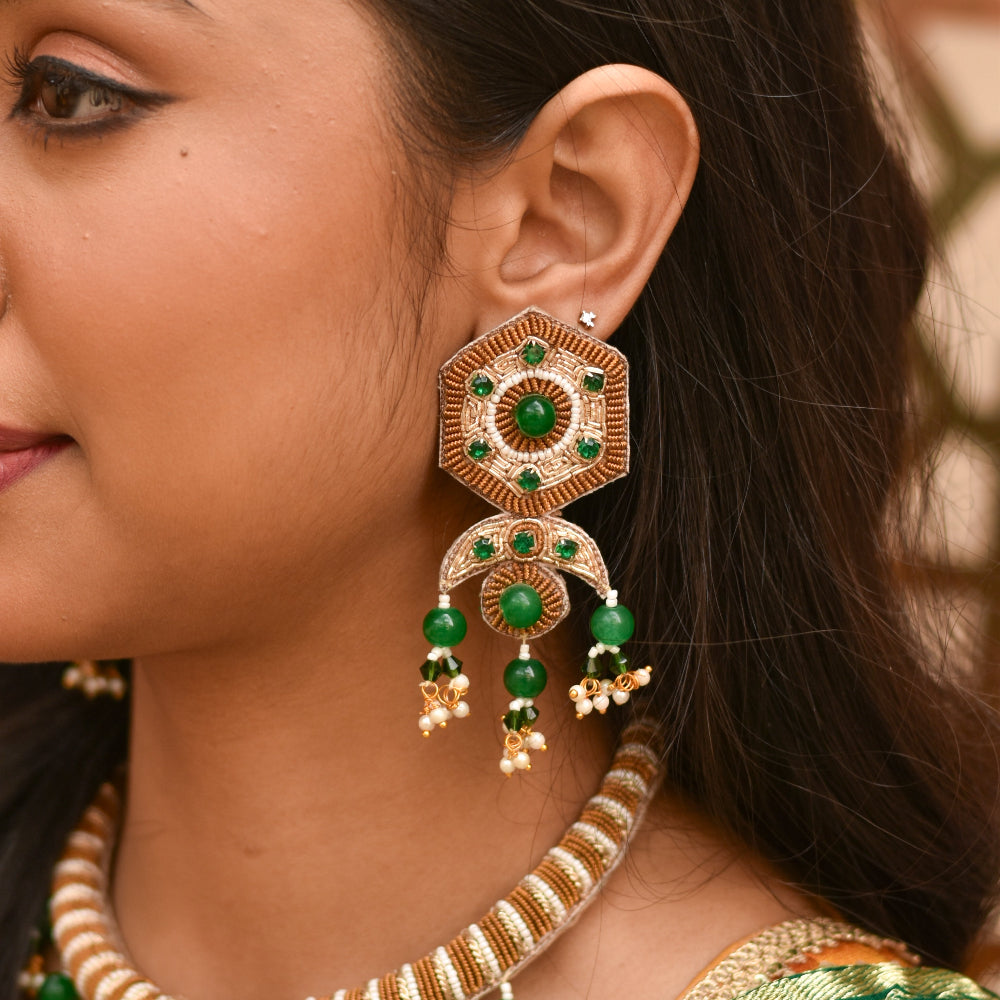 Woman wearing egyptian queen inspired handmade earrings for her haldi mehendi