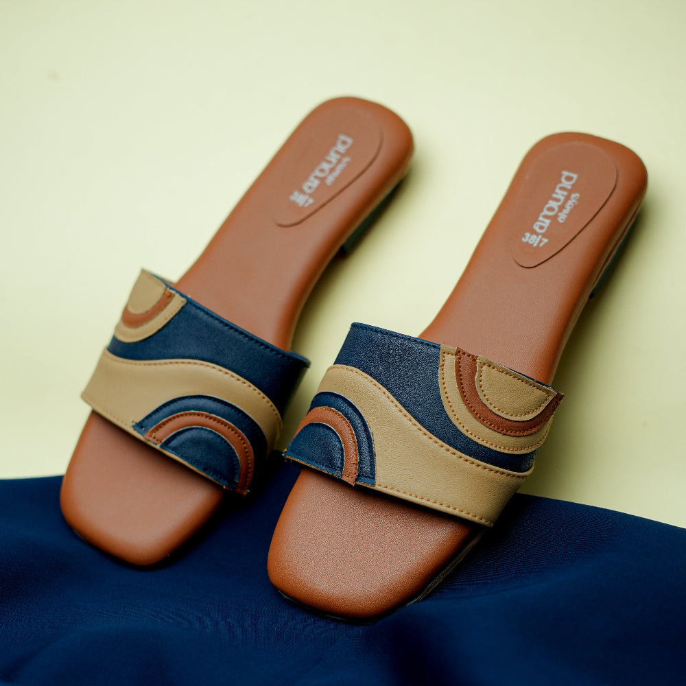 Tan and navy women’s slide with layered geometric strap
