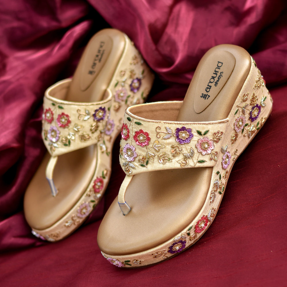 Designer gold wedges with pink, red, and purple floral motifs and comfort sole