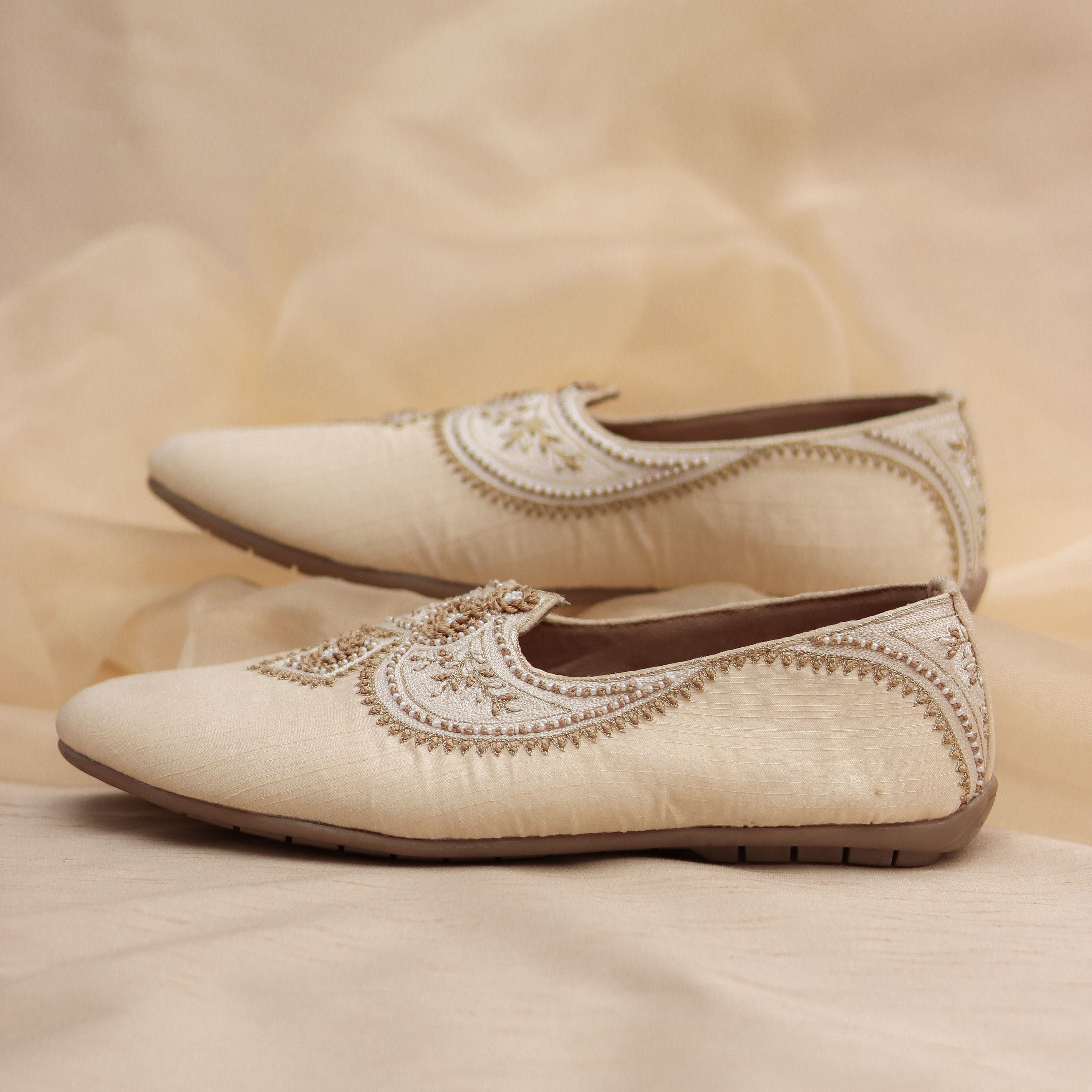 Ivory silk mojris with tone-on-tone embroidery and floral beadwork.