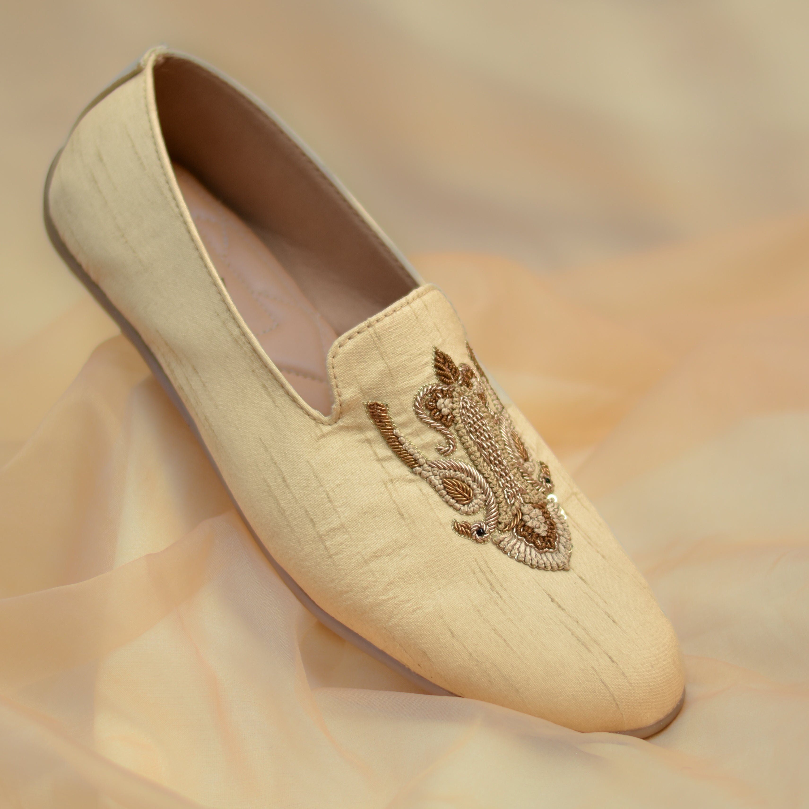Neutral loafer with intricate handcrafted embroidery, layered threadwork and rich textured detailing across the upper