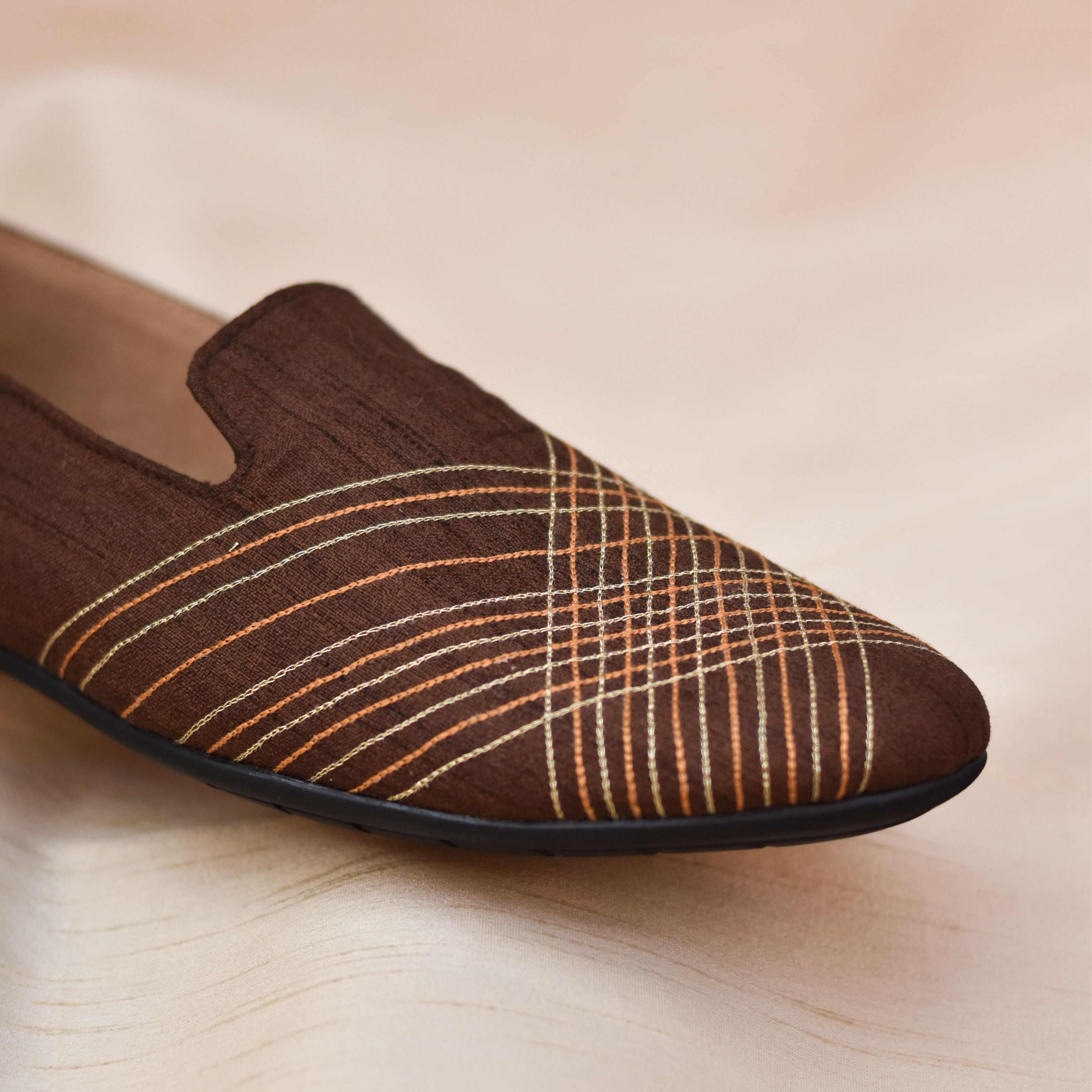 Elegant ethnic footwear for men with crisp detailing and formal silhouette.