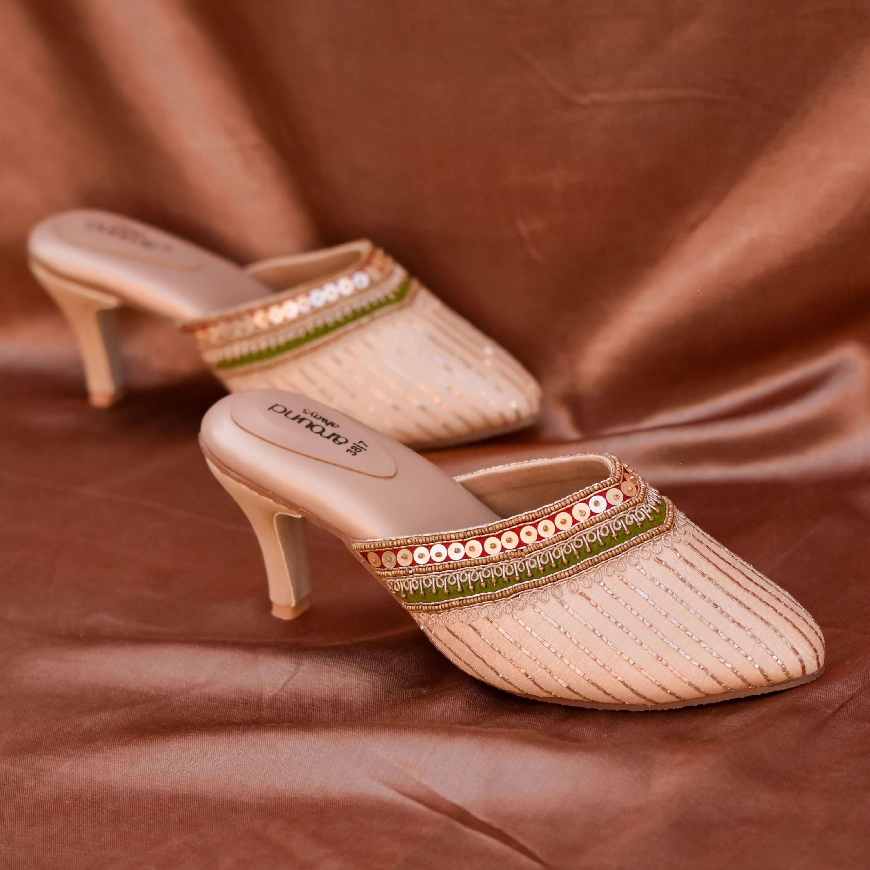 Designer gold mid-heel sandals with festive embroidery and sequins.