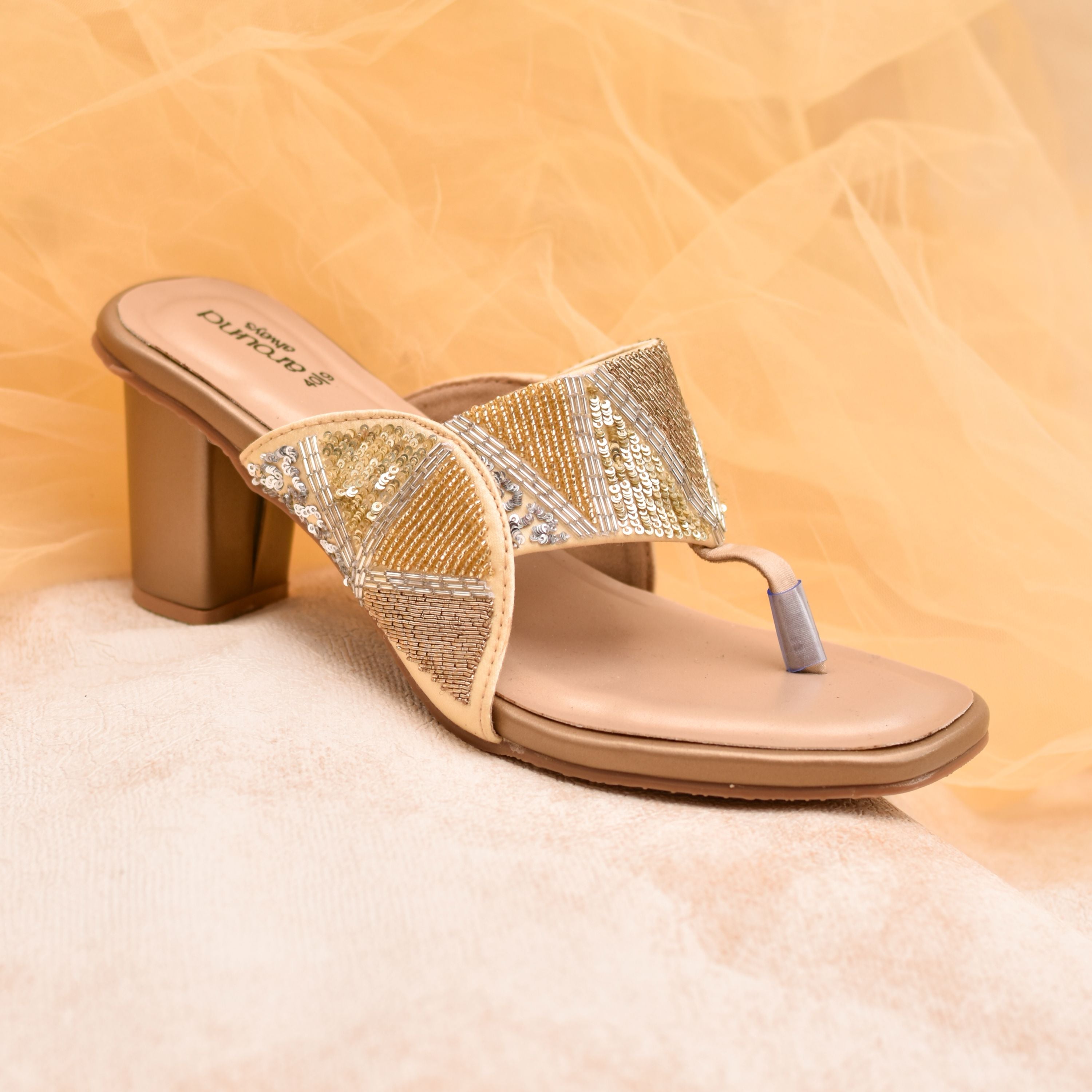 Festive women’s heels with thumb-grip style and beaded straps.