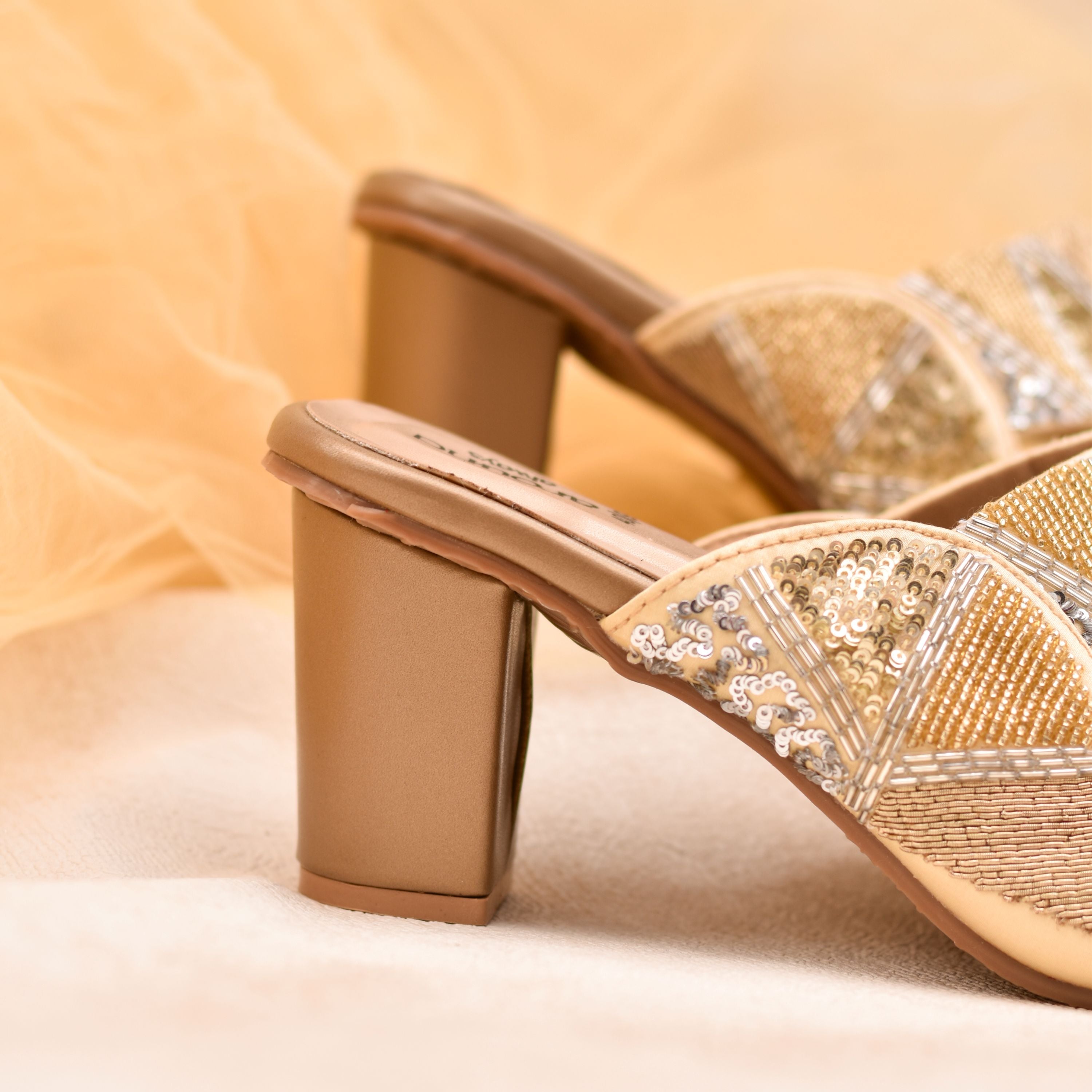 Party wear golden heels with Kolhapuri style embellished straps.