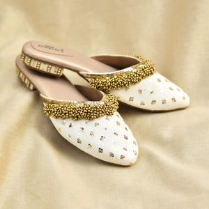 Ivory slip-on sandals with golden Ghungroo border and sequin flowers