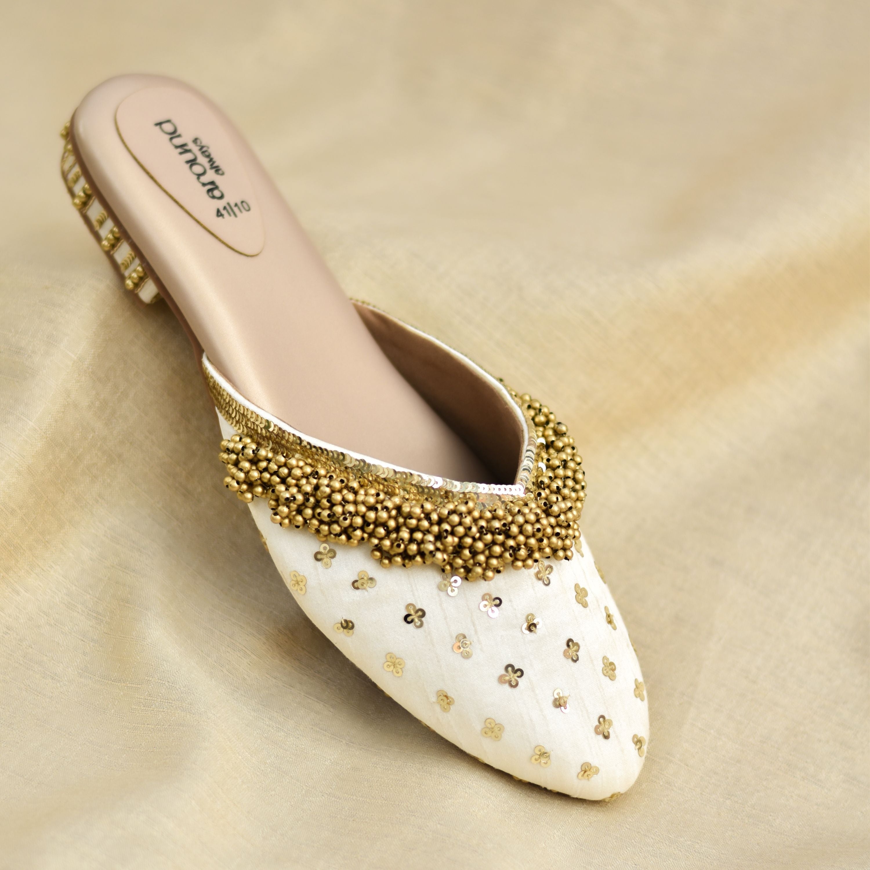 Handcrafted ivory heels with floral sequins and clustered ghungroo.