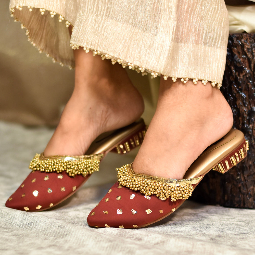Red ethnic slip-on heels with gold ghungroo embellishment for ethnic wear