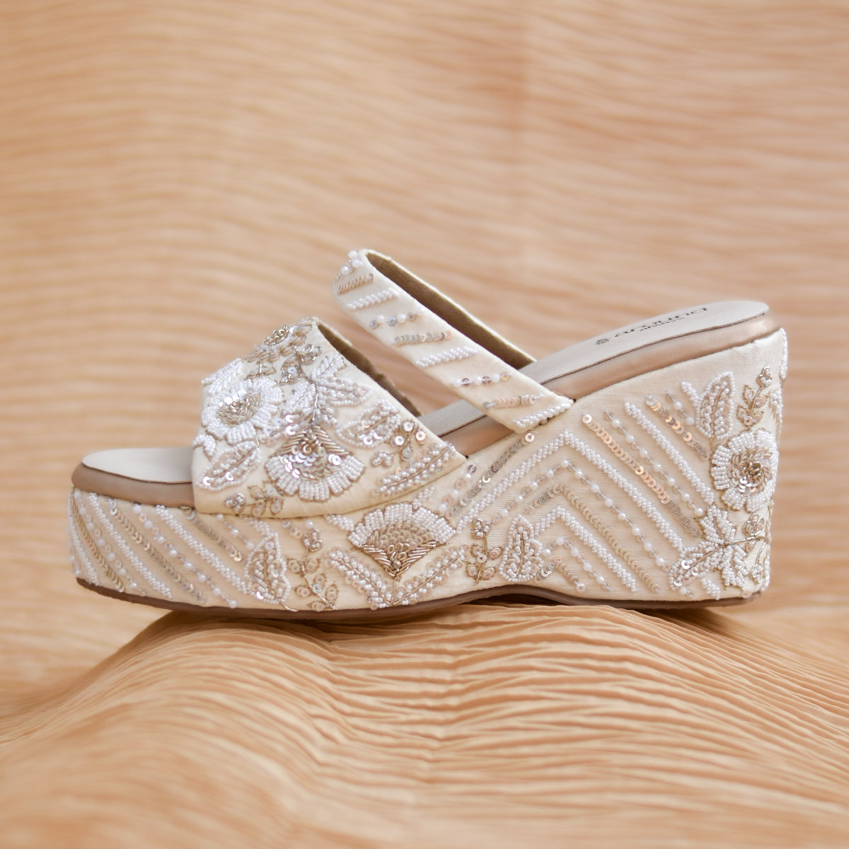 Designer ethnic wedges featuring white and ivory floral embroidery with a peeptoe strap for traditional outfits.