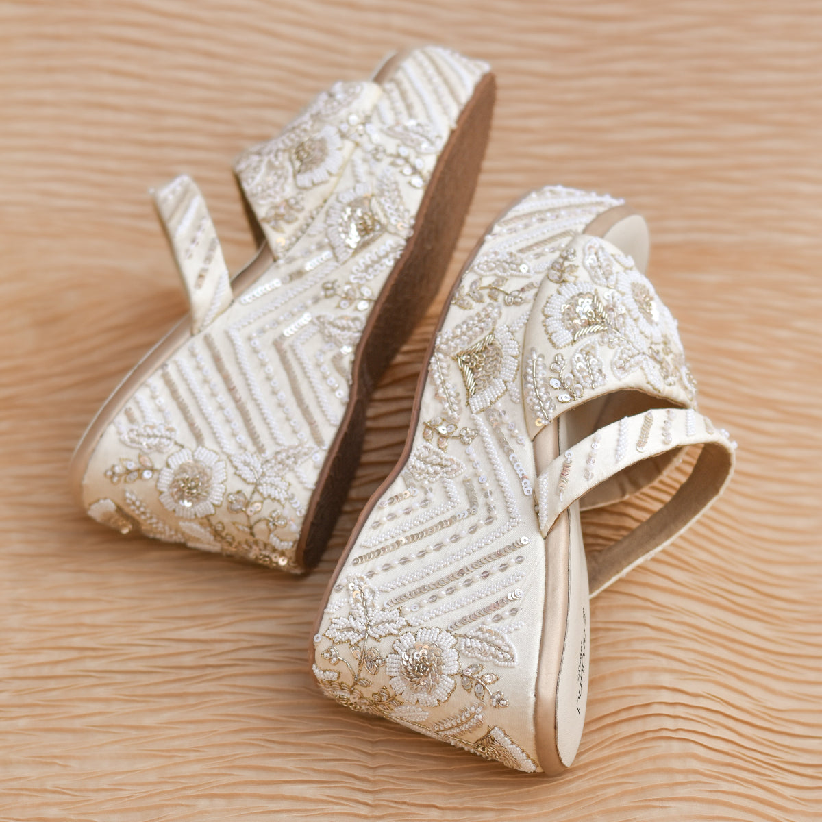 White embroidered wedding footwear for a classic sangeet outfit at a premium Indian wedding