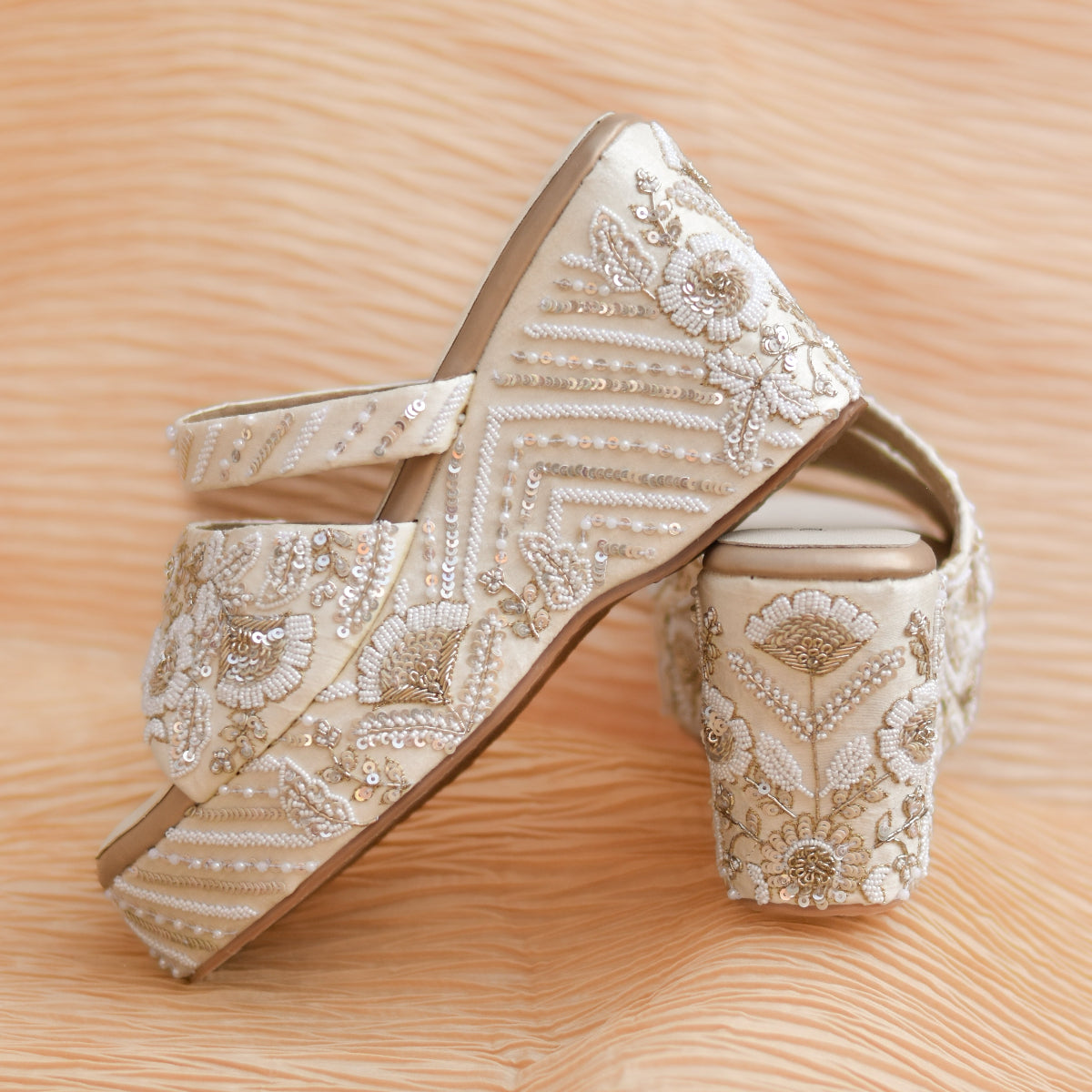 Stylish tone on tone bridal heels for an ivory tissue lehenga