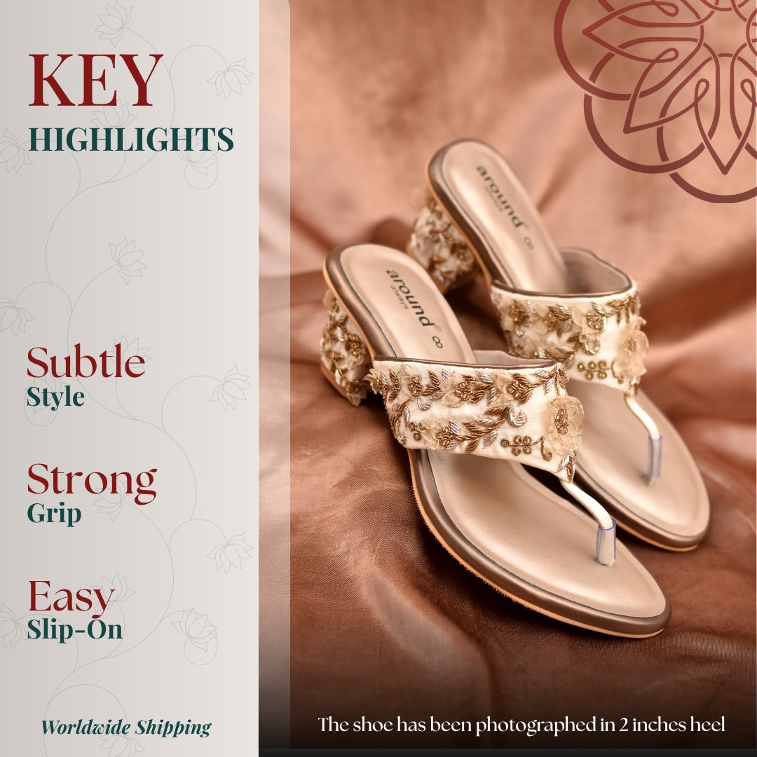 Beige embroidered block heel sandals with floral detailing and elegant design