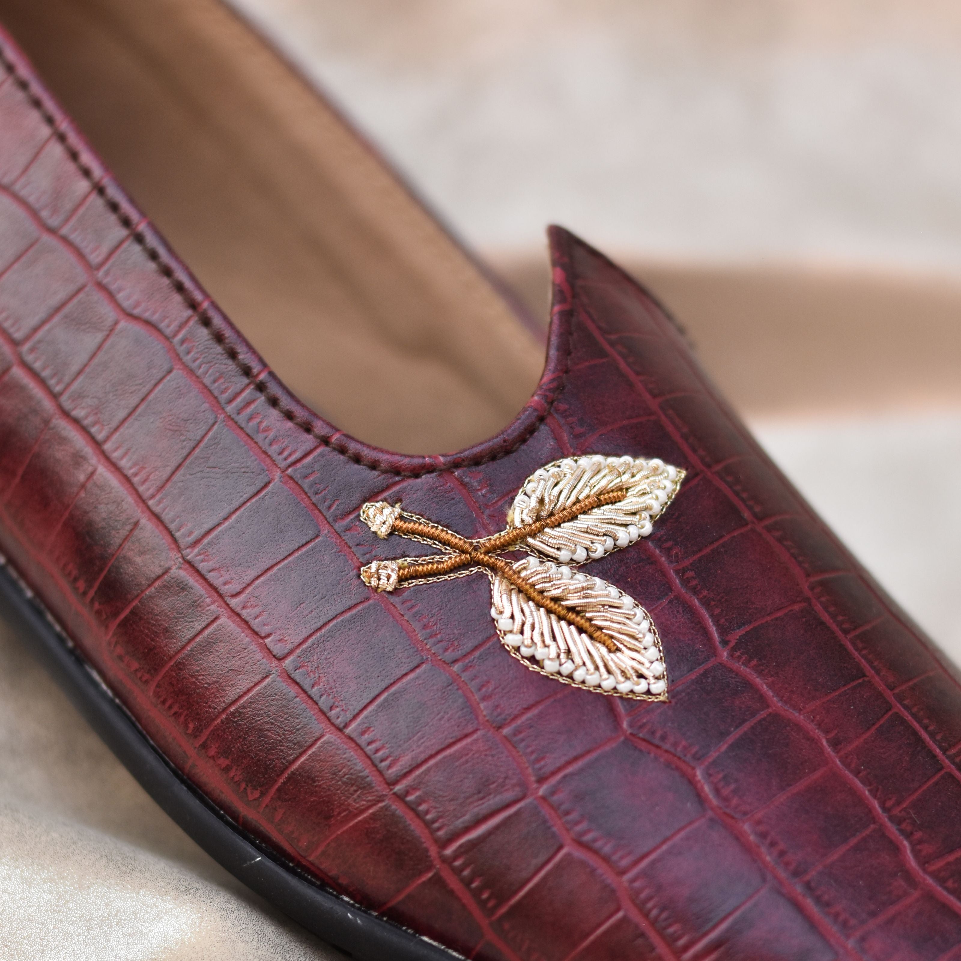 Traditional Indian footwear with embossed texture and subtle gold design.