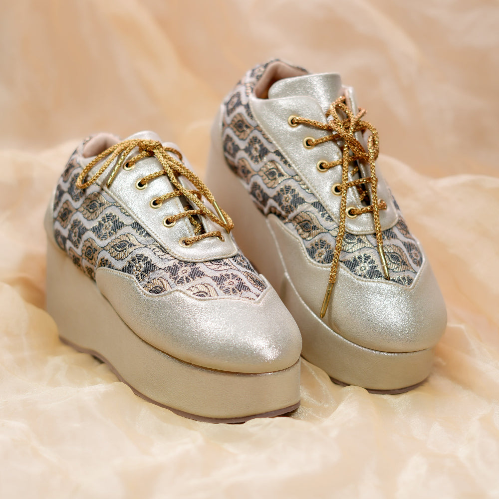 Metallic wedge sneakers with traditional woven motifs and elevated platform sole
