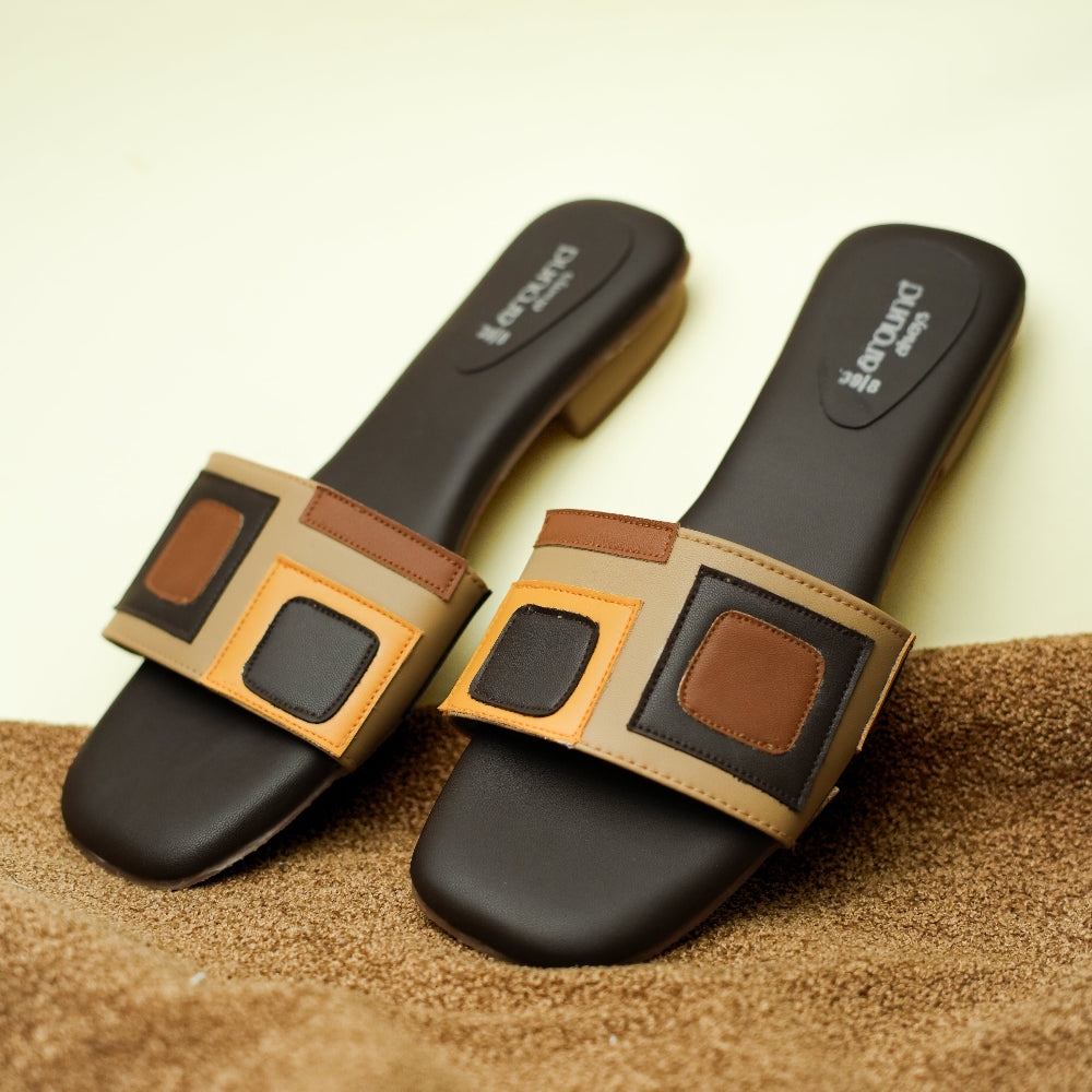 Black slide sandal featuring bold square appliqué details
